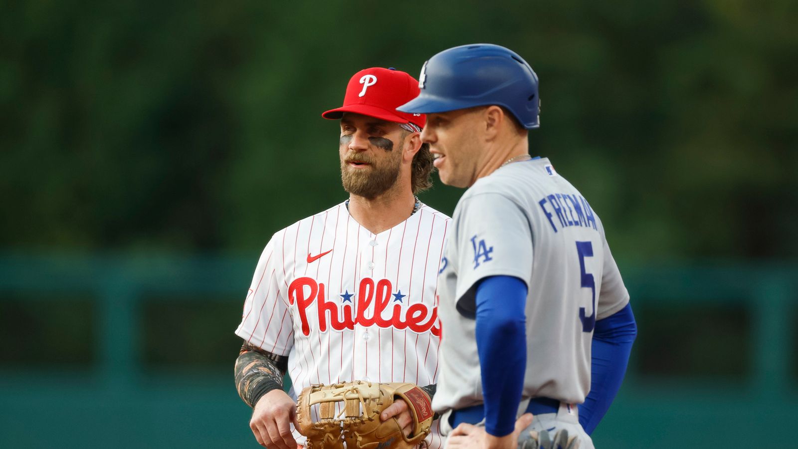 Bryce Harper and Freddie Freeman chat during the game