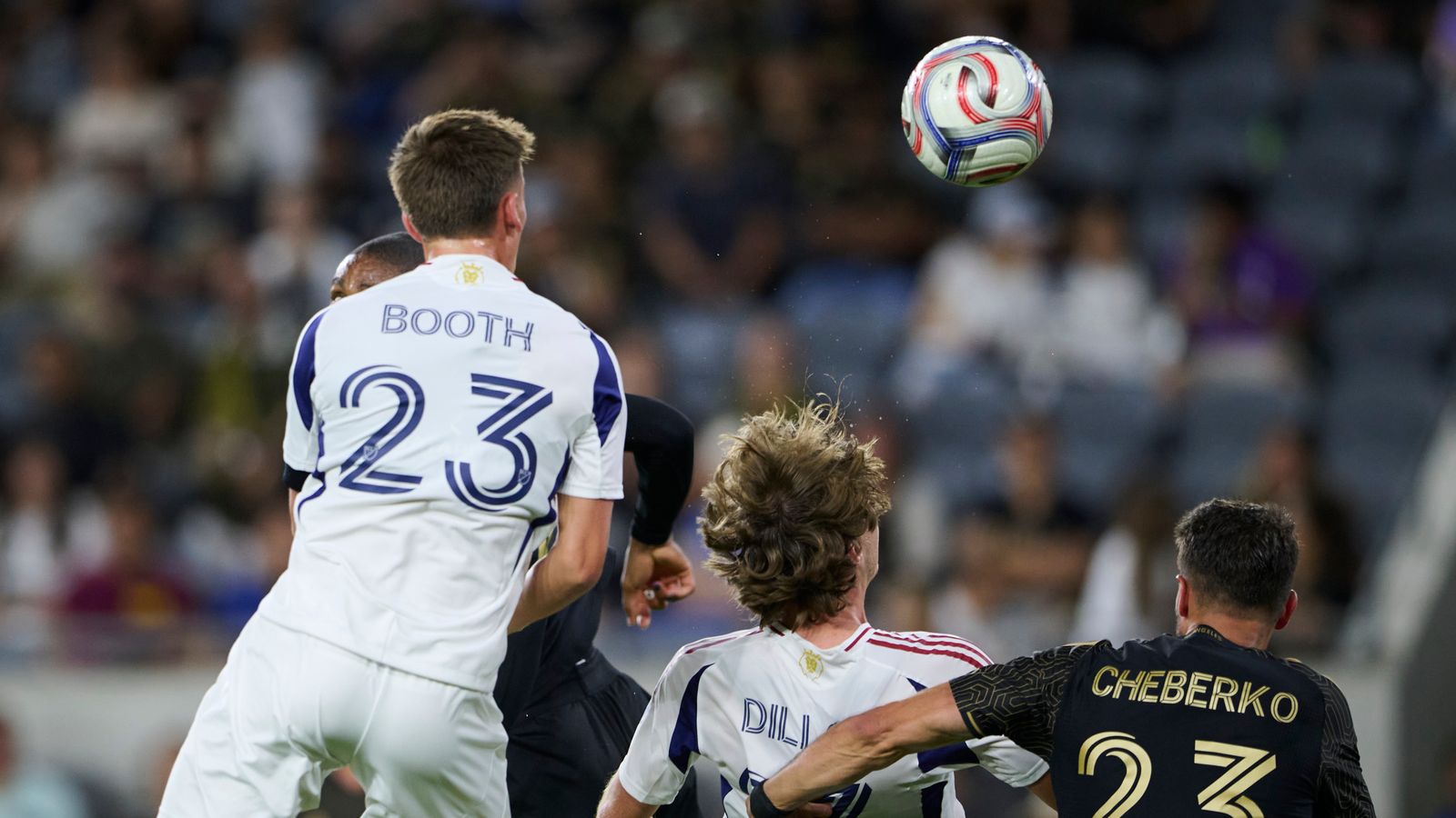 Zach Booth of RSL jumps for the ball against LAFC