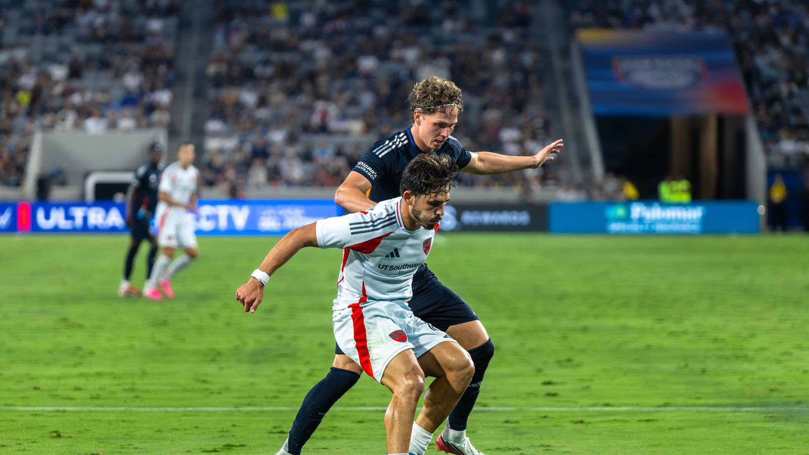 Ran Benjamin skillfully shields the ball from Onni Valakari.