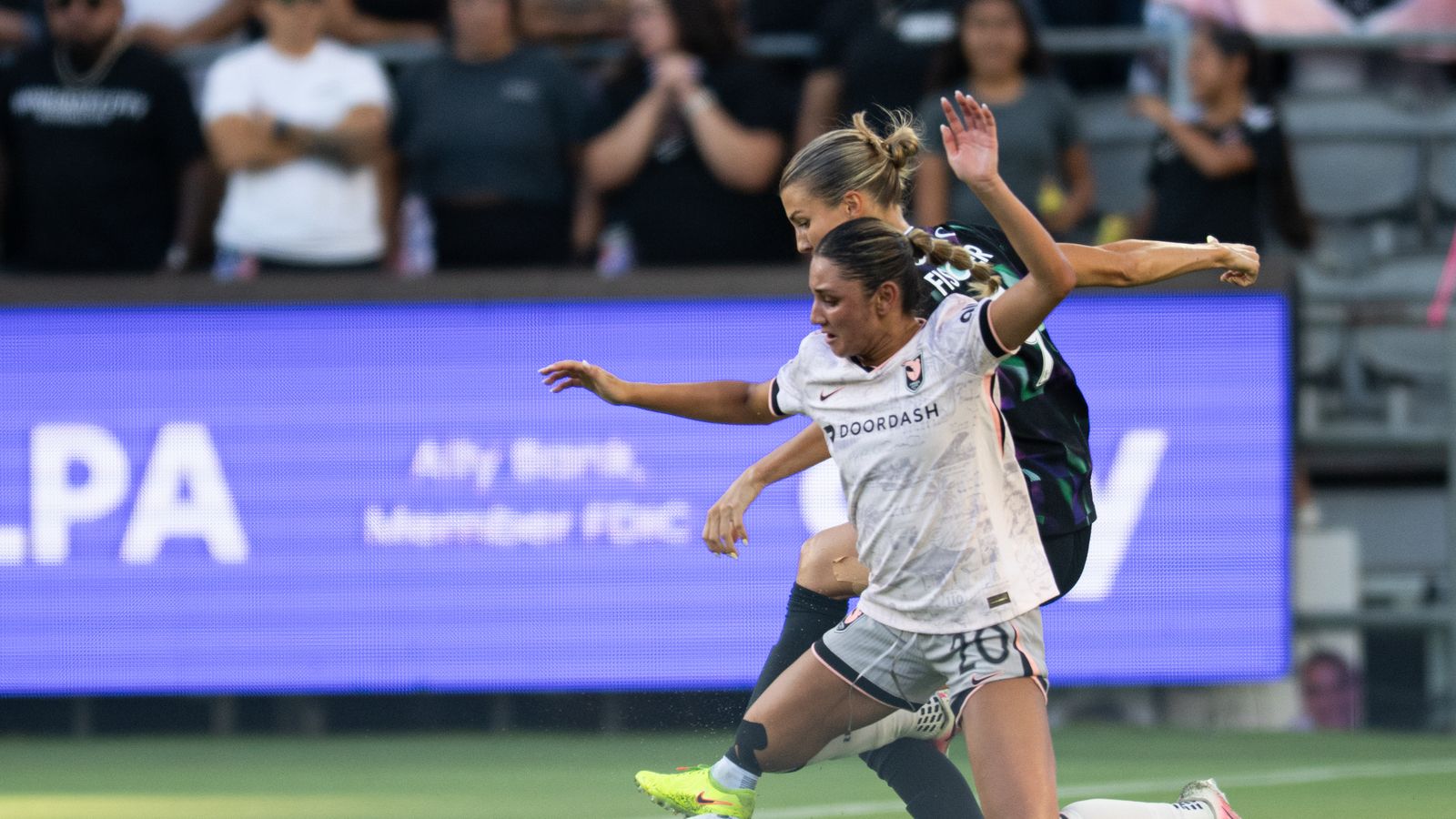 Gisele Thompson tackled in a tense moment of the NWSL match