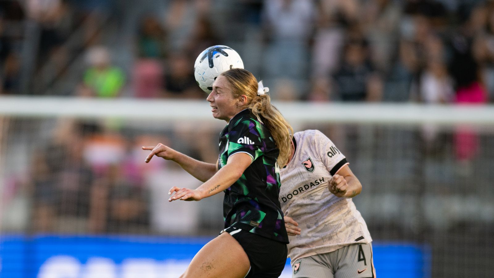 Sarah Weber heads the ball in a key play for Racing Louisville
