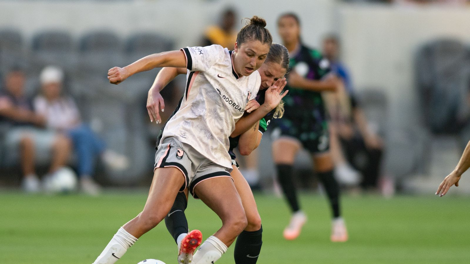 Carina Lageyre shields the ball from Racing Louisville opponents