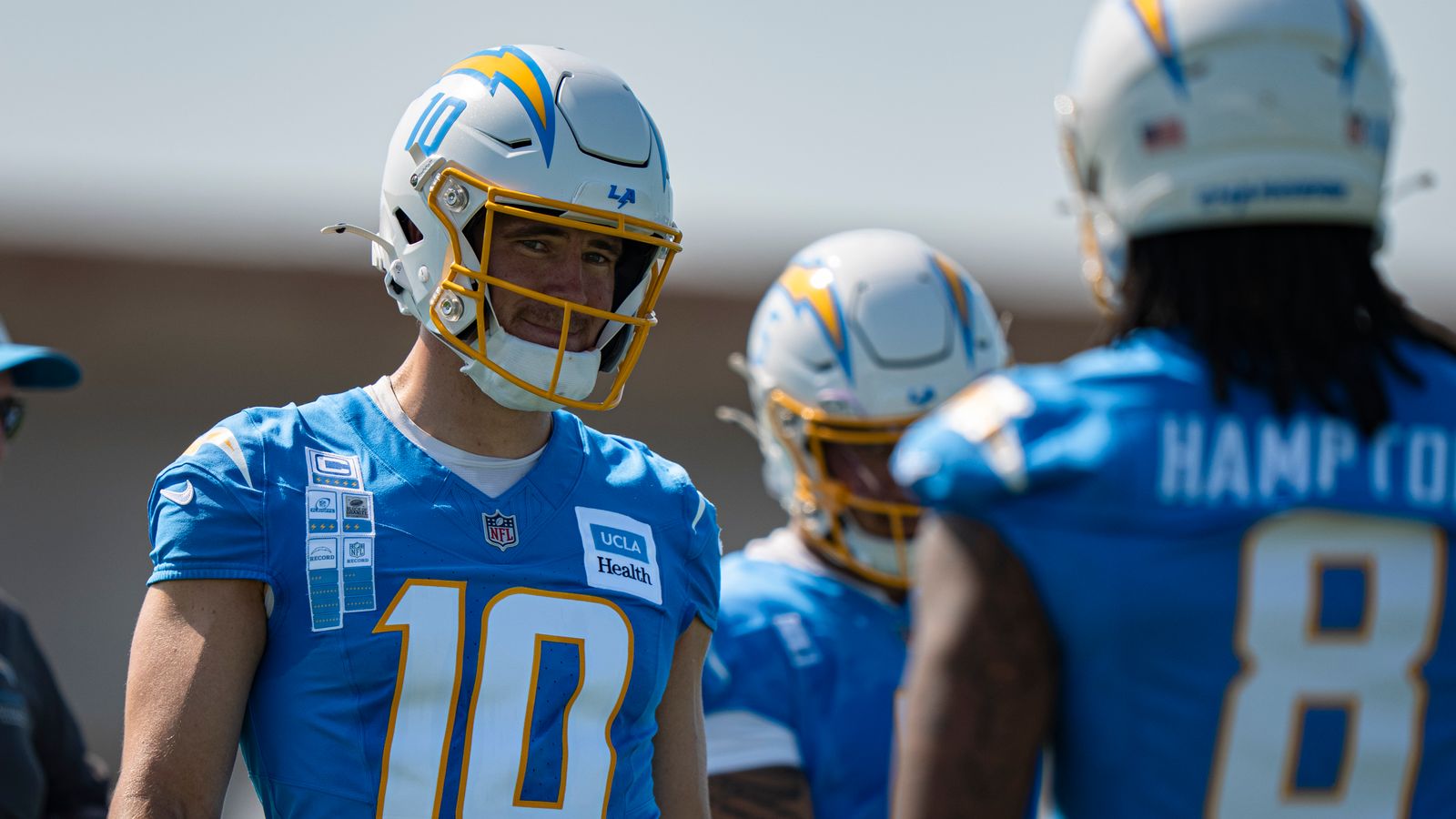 Herbert and Hampton Share a Moment at Training Camp