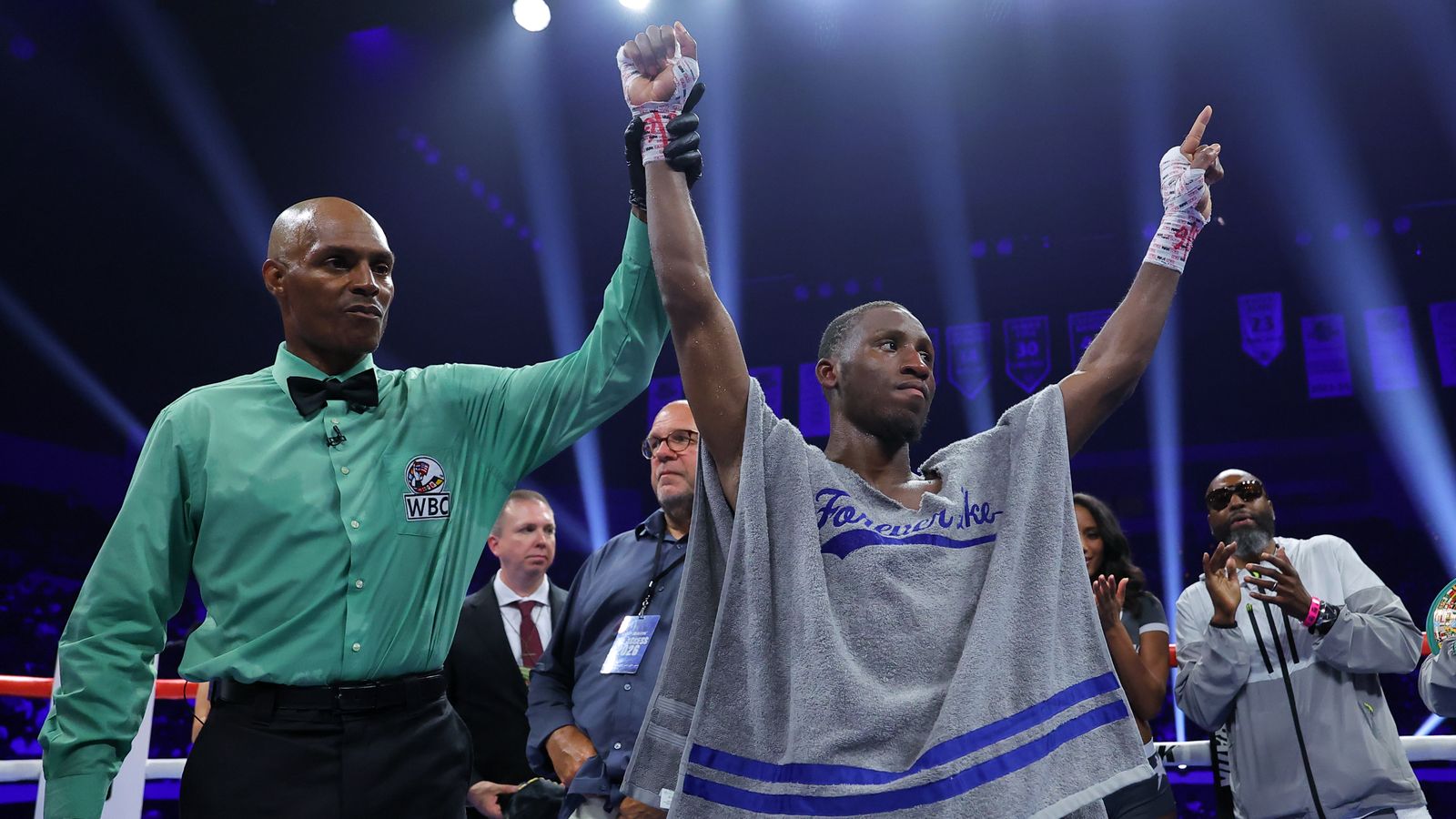 Bruce Carrington has his hand raised after retaining his WBC featherweight title against Rene Palacios.