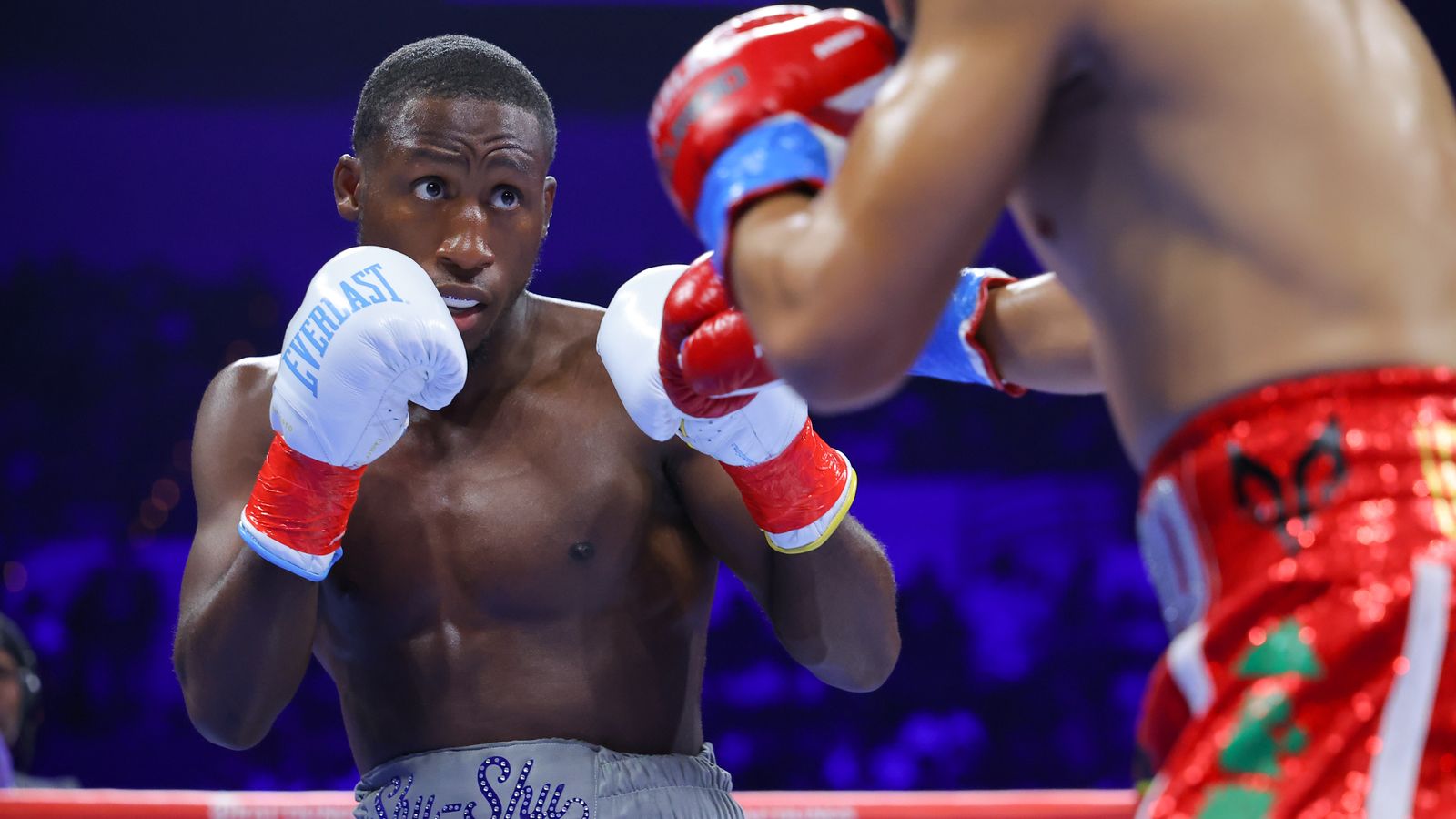 Bruce Carrington keeps his guard up against Rene Palacios in their WBC featherweight title bout.