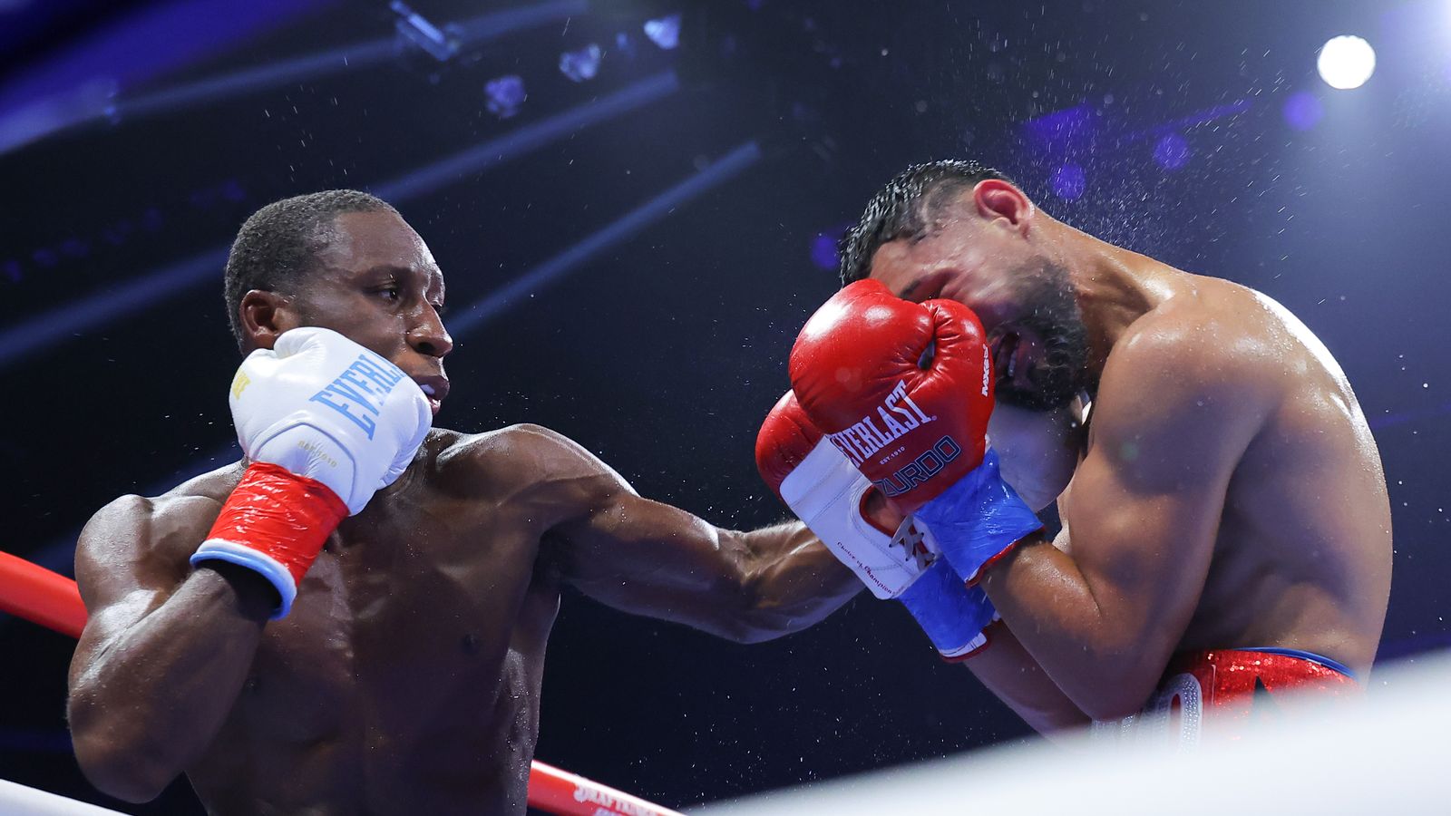 Bruce Carrington lands a left hand on Rene Palacios during their WBC featherweight title fight at Wolstein Center.