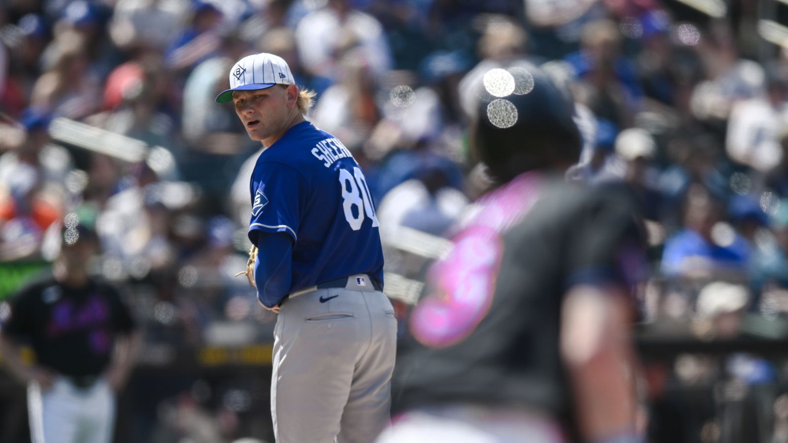 Dodgers' Emmet Sheehan watches Mets' Carson Benge at first base.