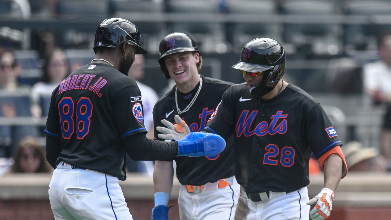 Mets' Tyrone Taylor celebrates a three-run homer with teammates.