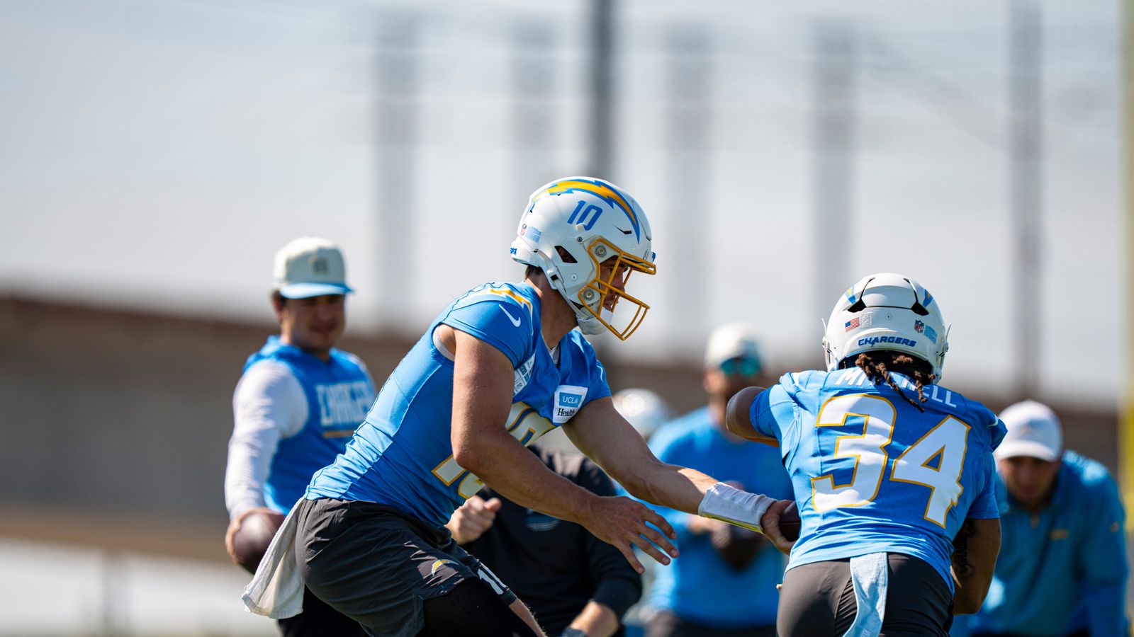 Justin Herbert Hands Off to Keaton Mitchell in Training