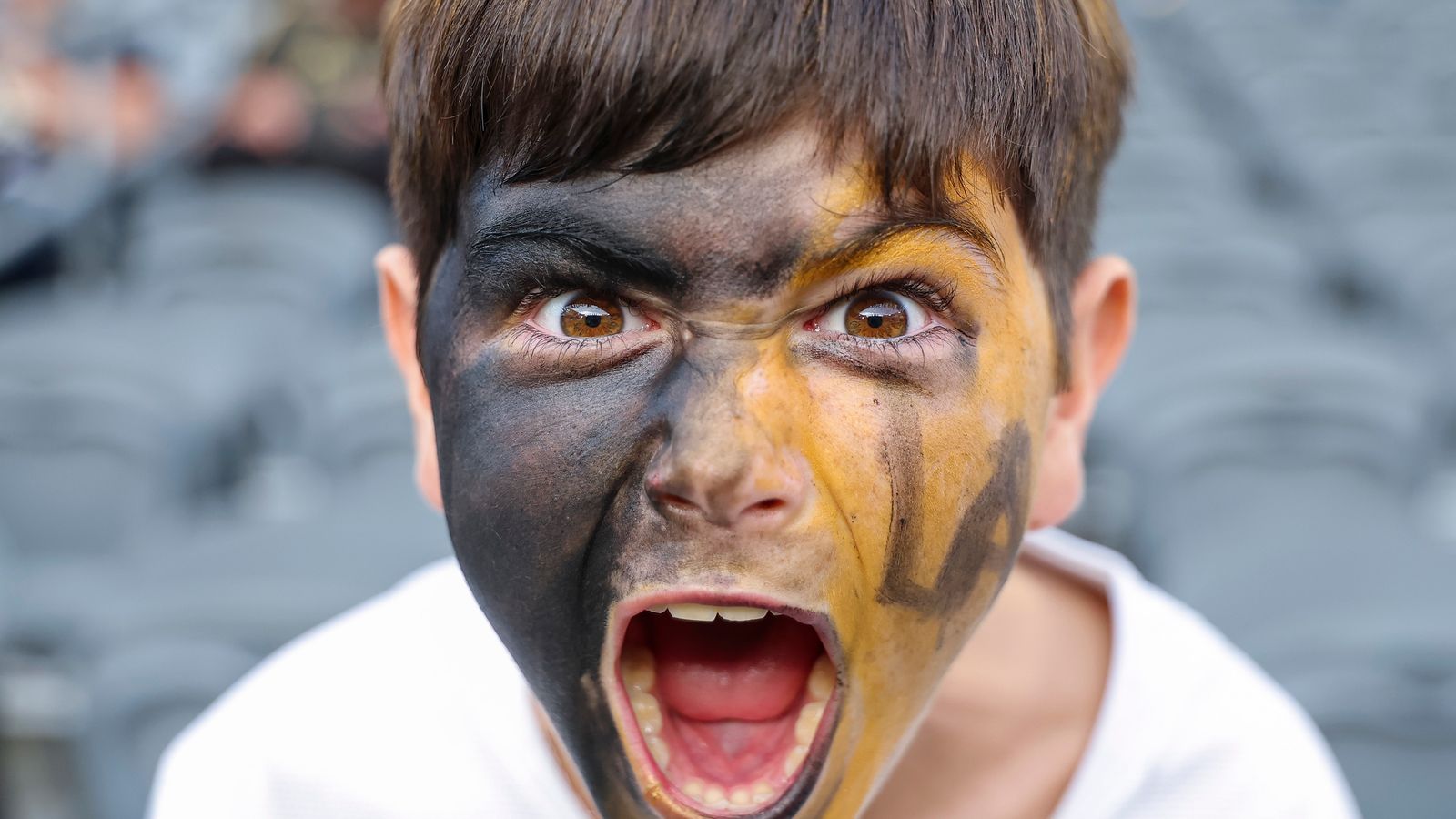 Excited young LAFC fan cheers before the Leagues Cup match