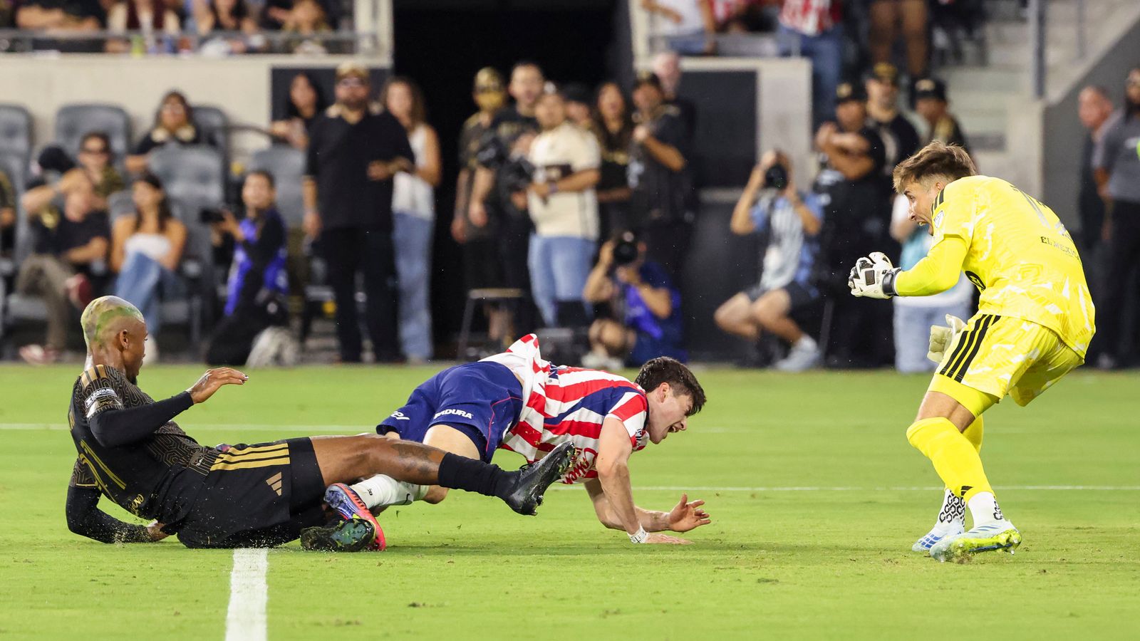 Armando González tackled by Nkosi Tafari in the penalty area
