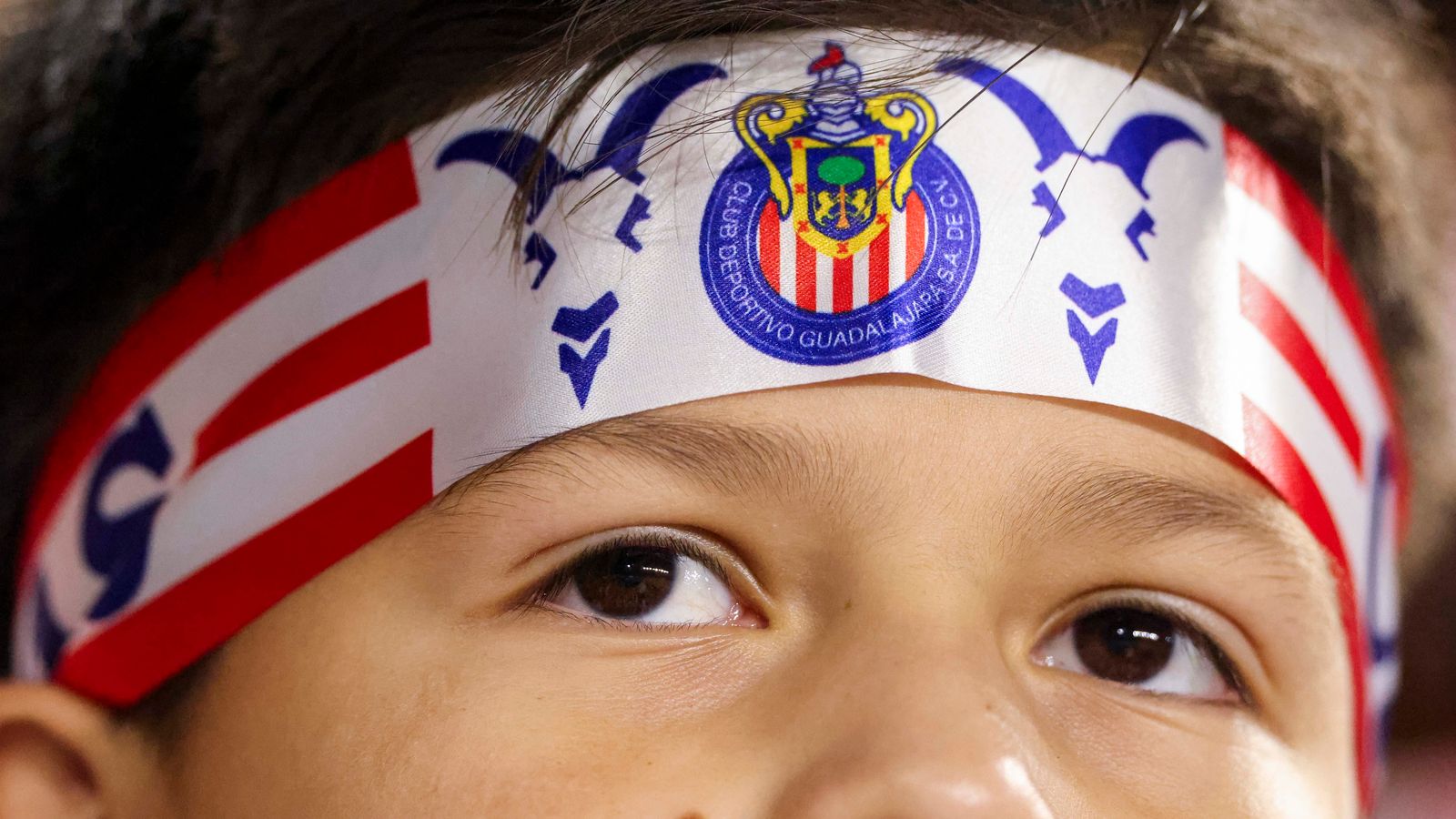 Young Chivas fan watches the match with anticipation