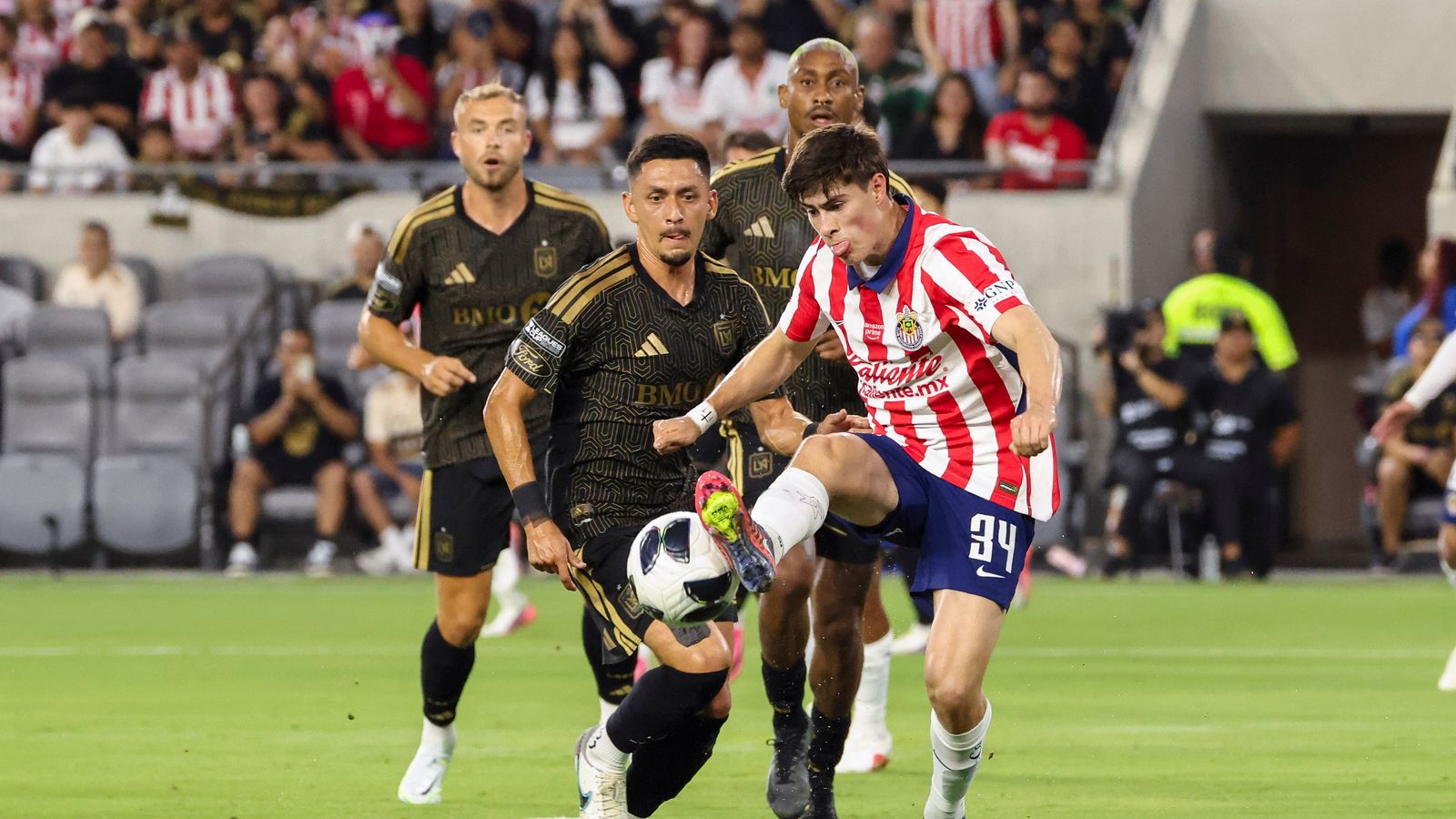 Armando González controls the ball under pressure from Mark Delgado