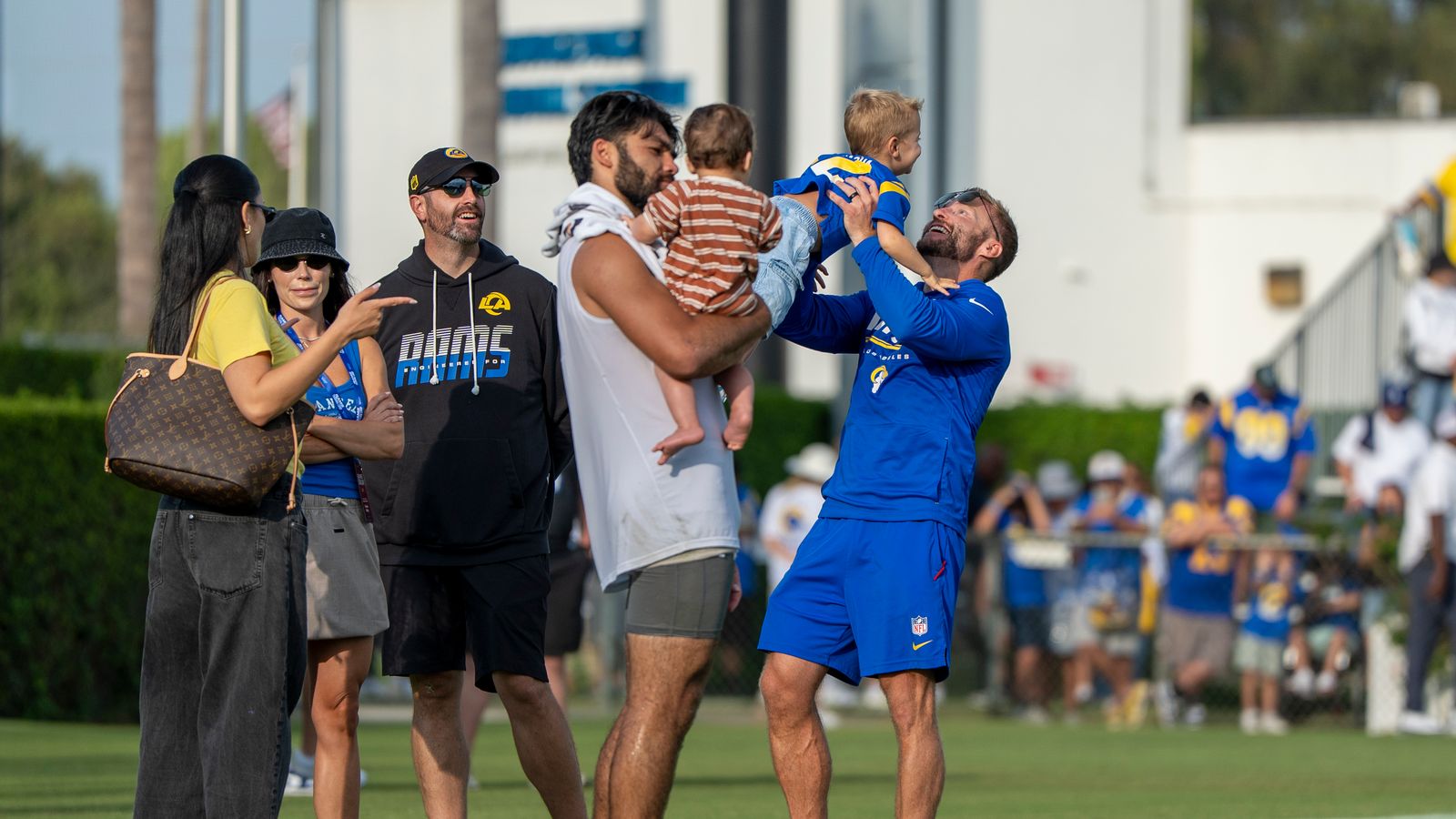 Puka Nacua #12 and Coach McVay with families at Rams training camp.