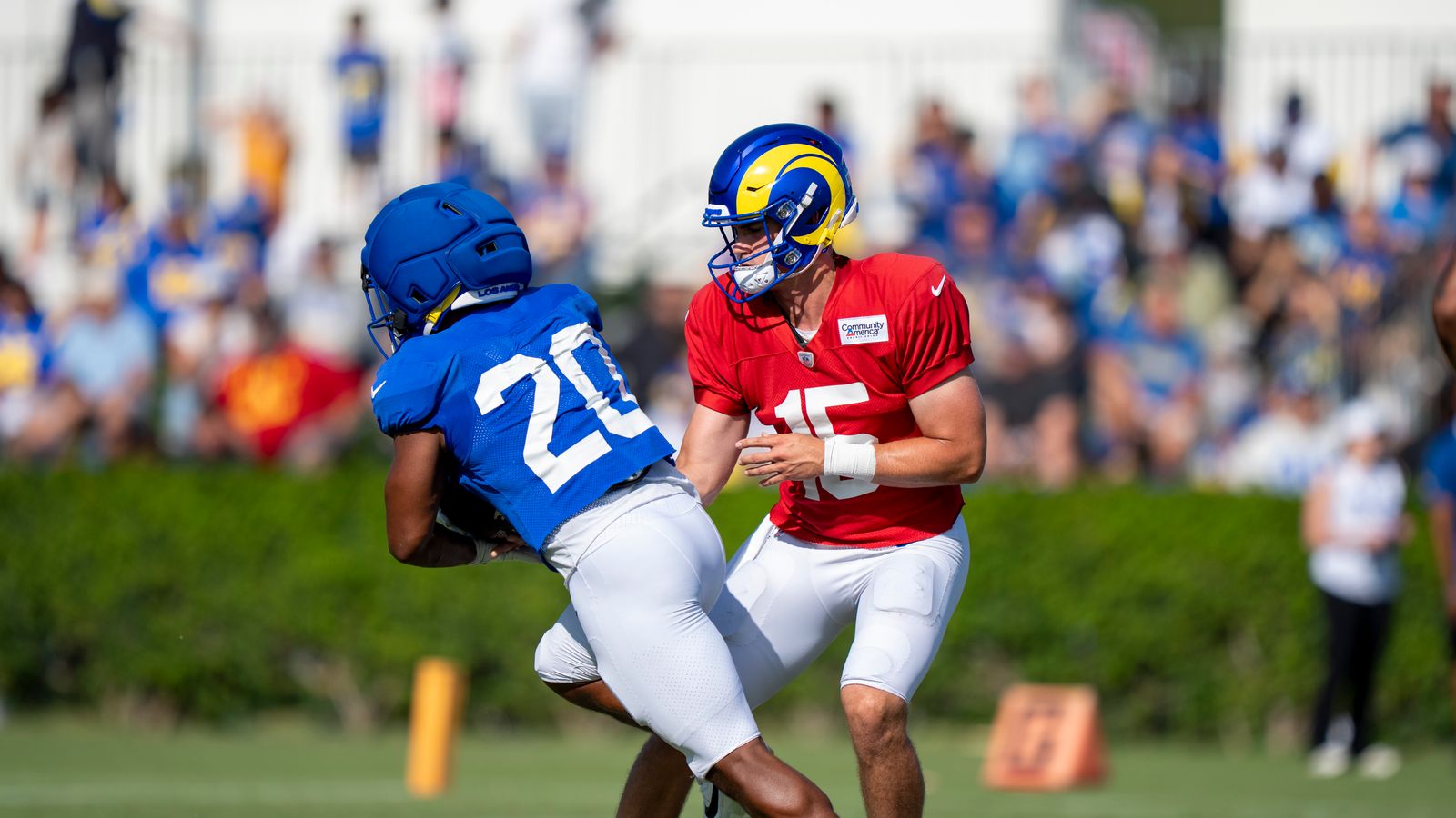 Ty Simpson #15 hands off to Ronnie Rivers #20 at Rams training camp