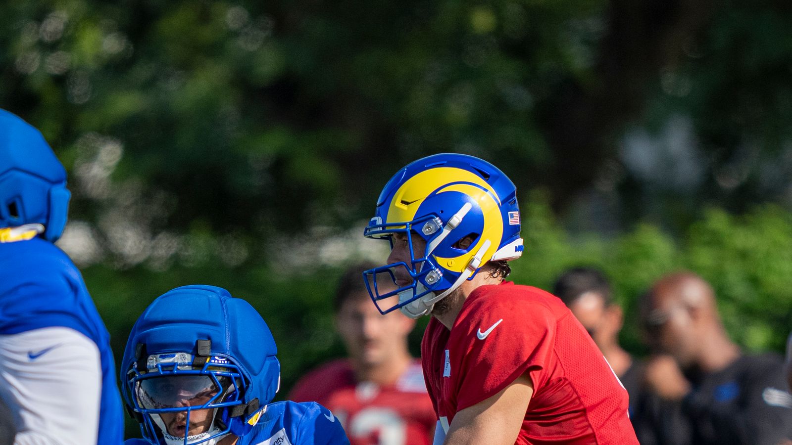 Matthew Stafford #9 hands off to Blake Corum #24 at Rams training camp