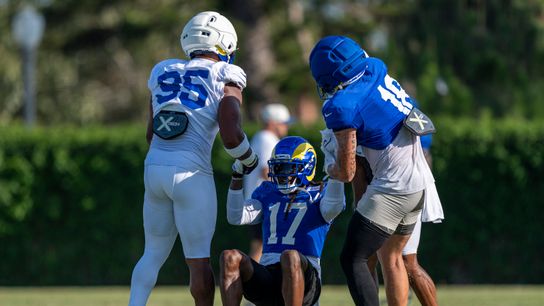Davante Adams assisted by teammates at Rams training camp