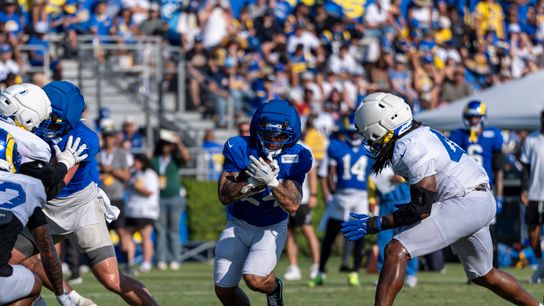 Blake Corum finds a gap during a training camp drill