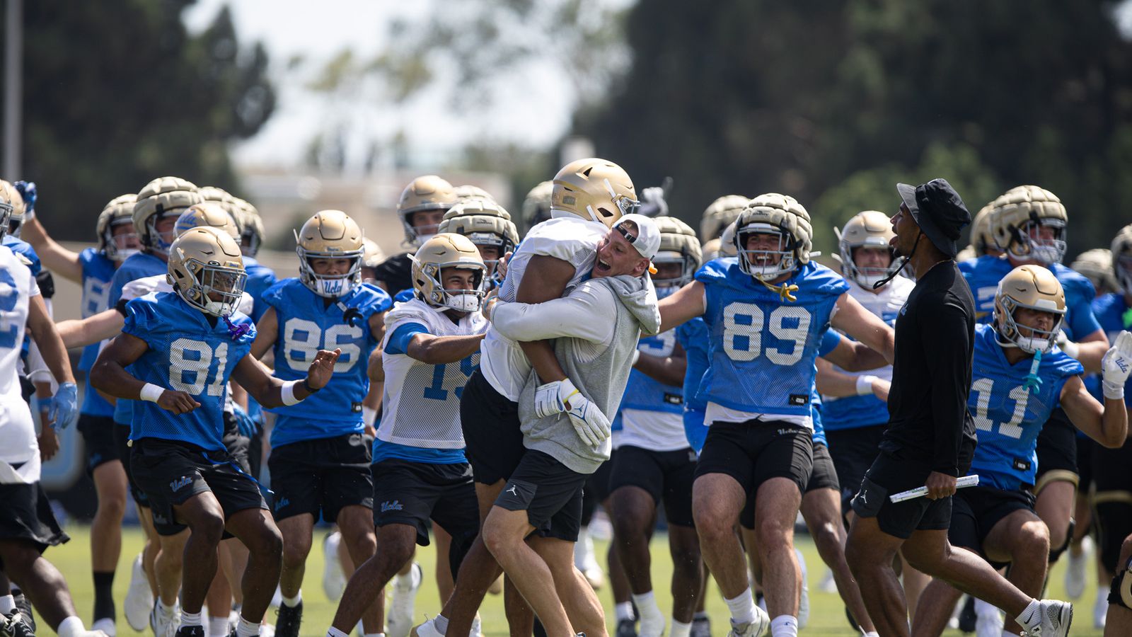UCLA celebrates a drill success at Wasserman Football Center.