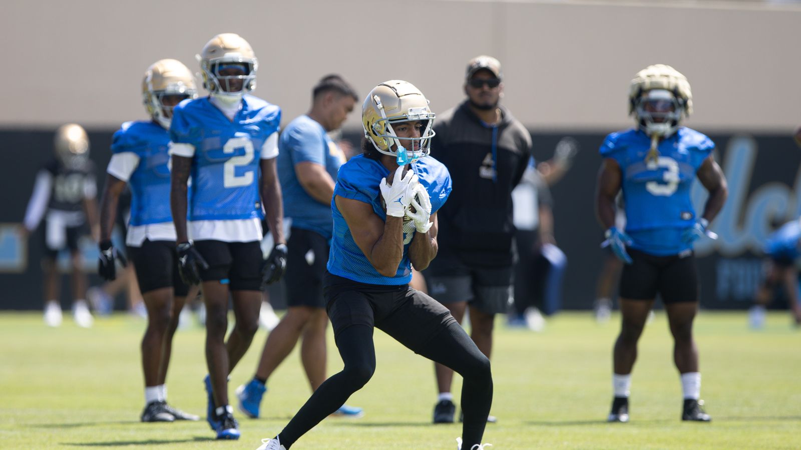 Aidan Mizell catches a punt during UCLA practice.
