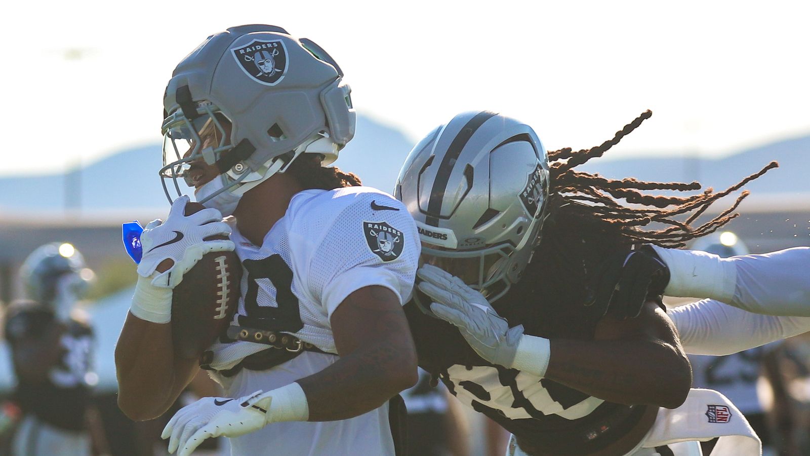 Devyn Perkins dodges Ian Thomas during Raiders Training Camp