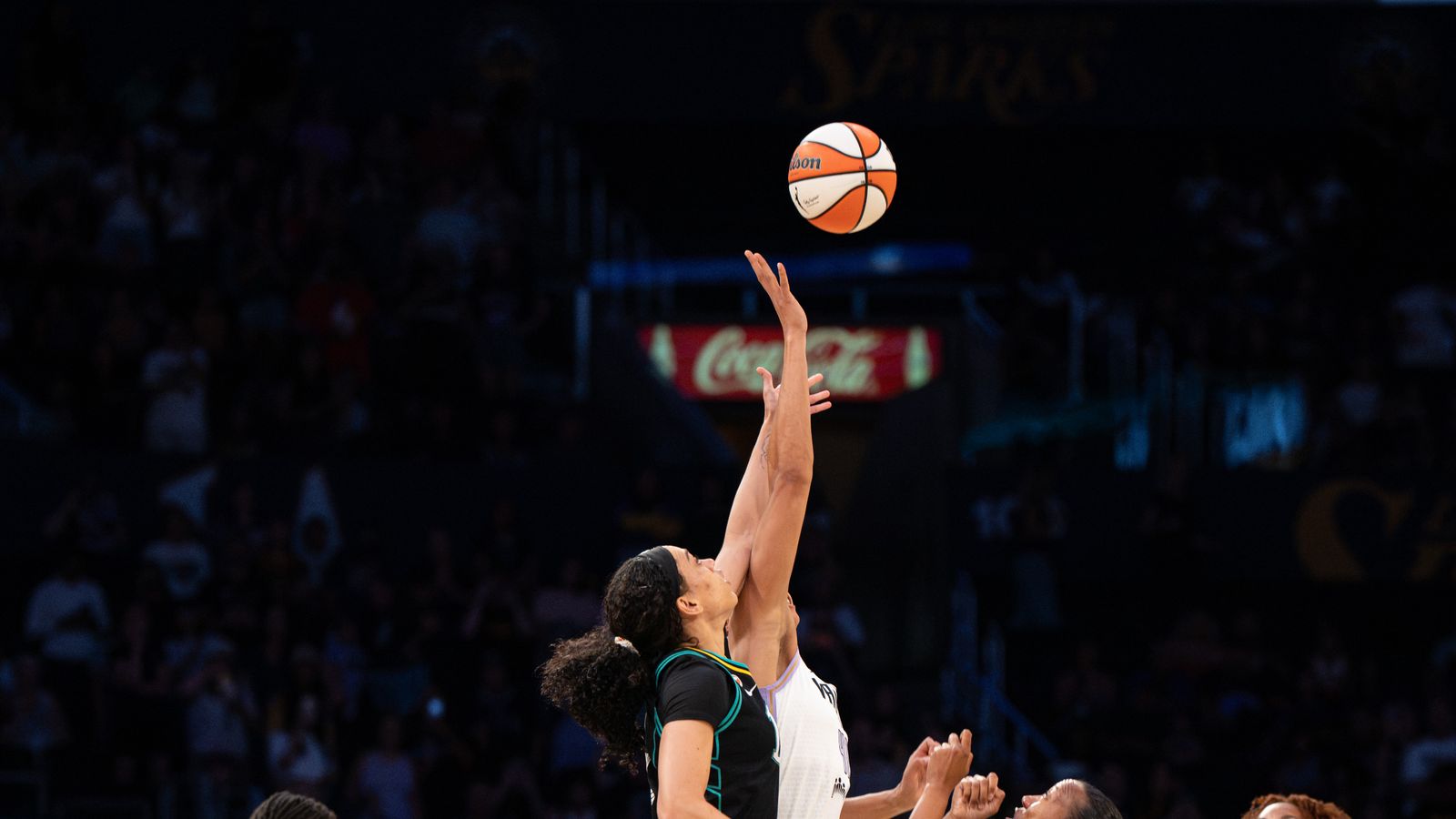 Kiah Stokes leaps for tipoff in WNBA game, Valkyries vs Sparks.
