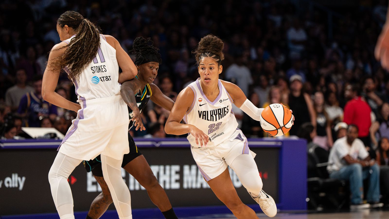 Veronica Burton dribbles under pressure in WNBA action.