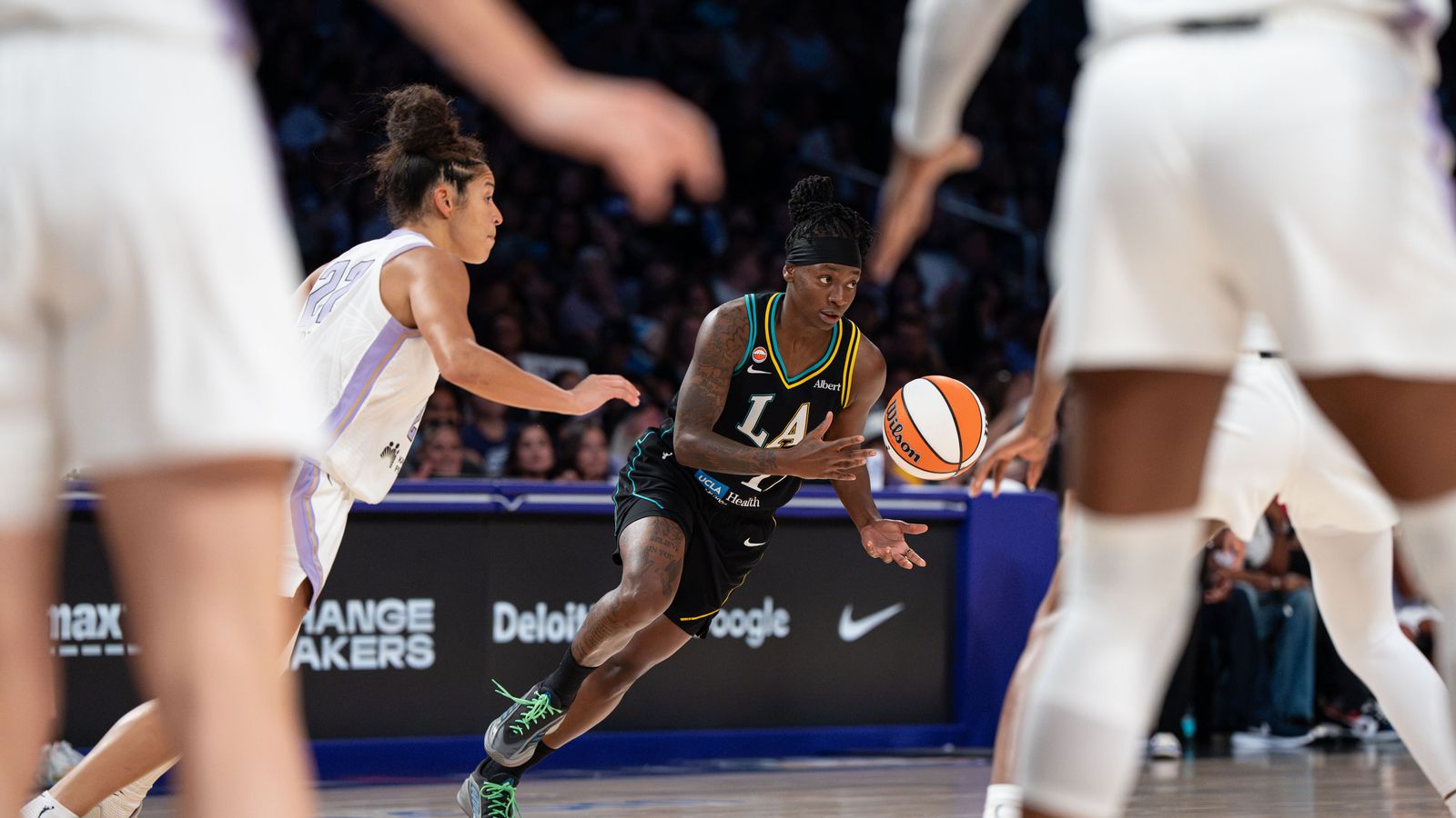 Erica Wheeler passes the ball in a tense WNBA clash.