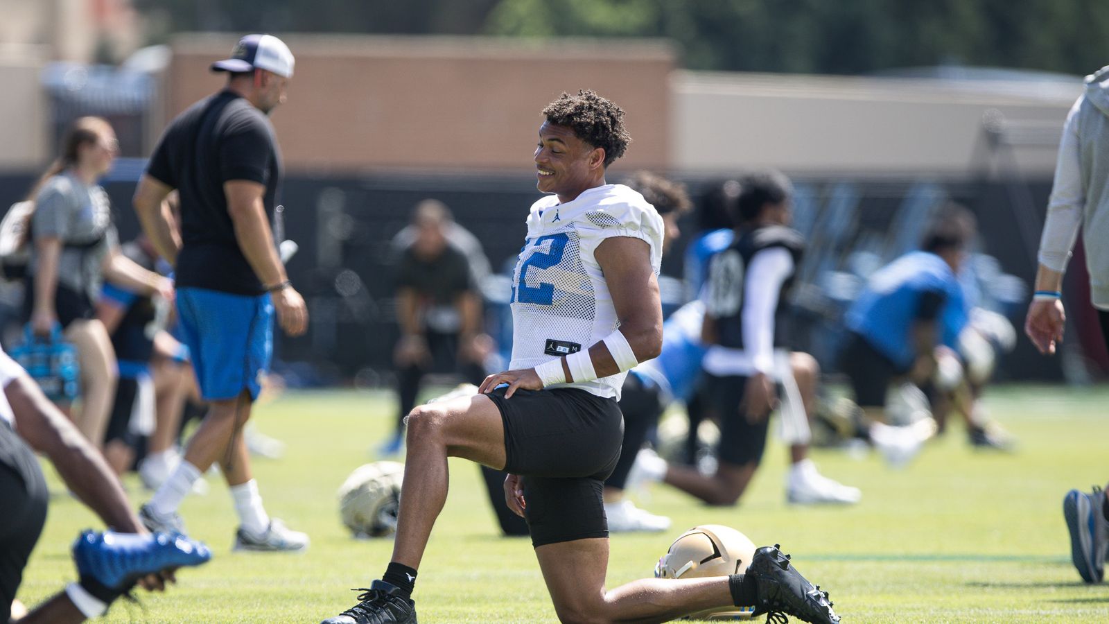 Malik Hartford stretches during UCLA's Friday practice.