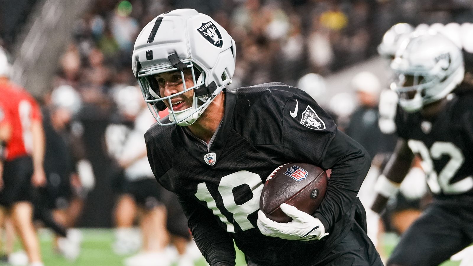 Jack Bech (18) runs with the ball during Raiders practice at Allegiant Stadium