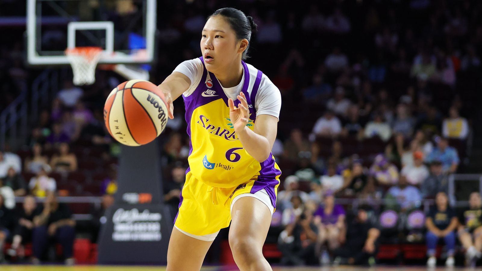 Jihyun Park passes the ball in a WNBA match