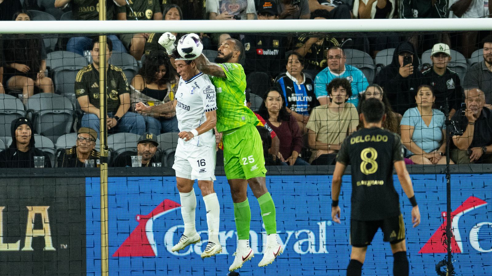 Goalkeeper Guillermo Allison punches the ball clear