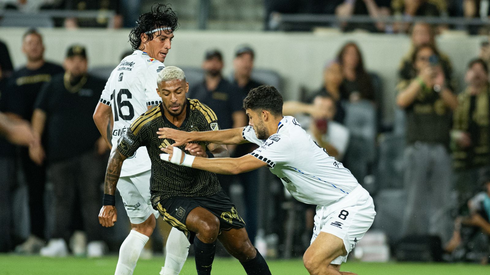 Denis Bouanga makes a daring move towards goal