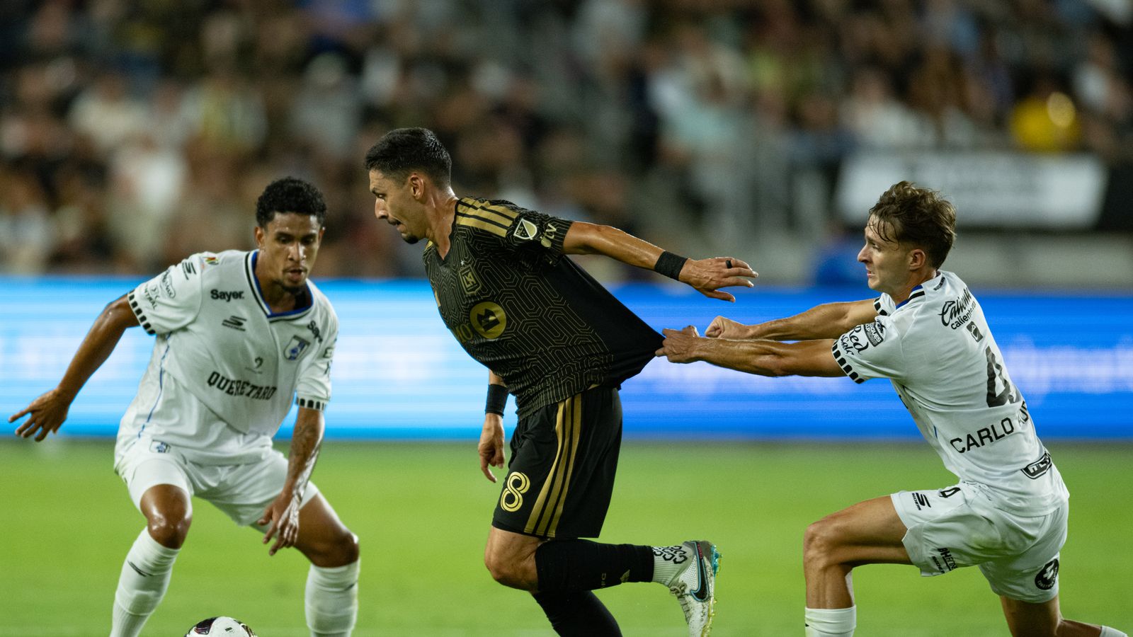 Mark Delgado fights for the ball in midfield battle