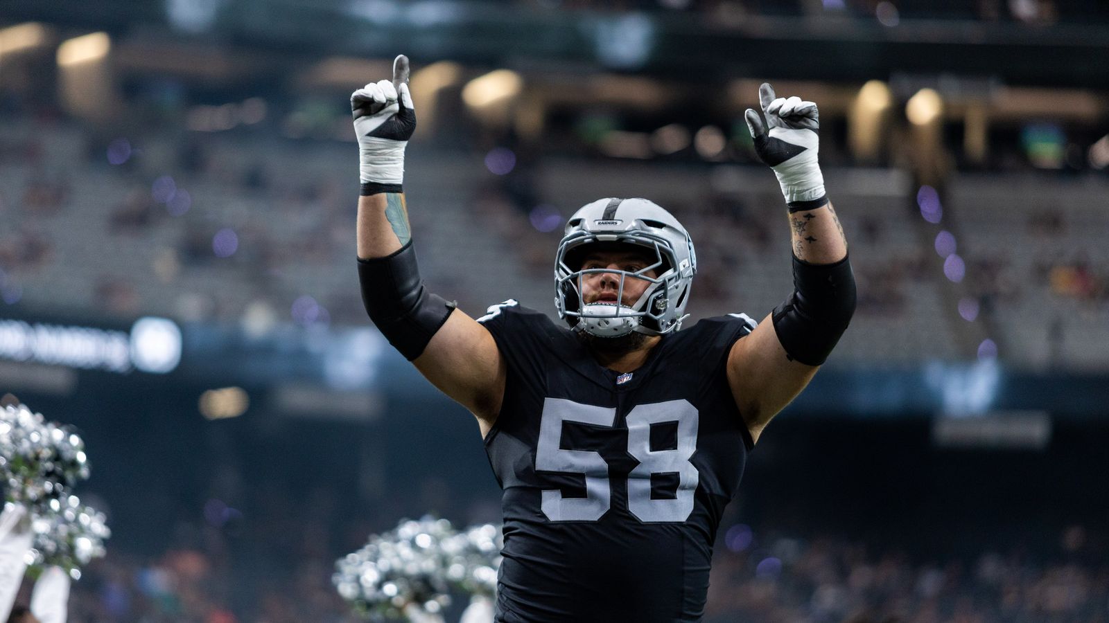 Jackson Powers-Johnson points skyward during NFL preseason intros