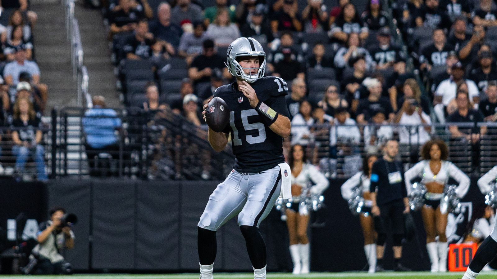 Fernando Mendoza prepares to pass in NFL preseason game