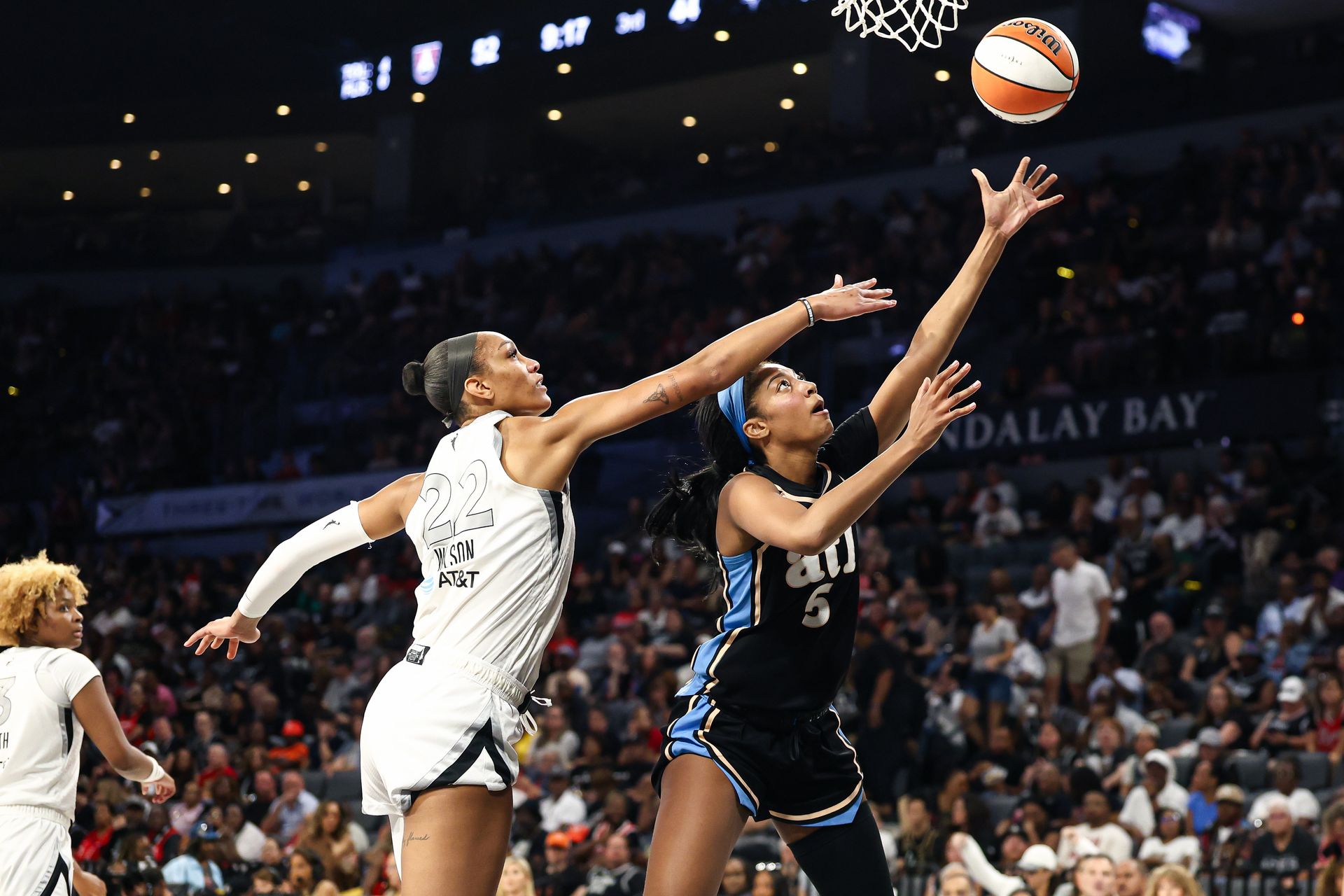 Angel Reese scores over A'ja Wilson in a WNBA matchup