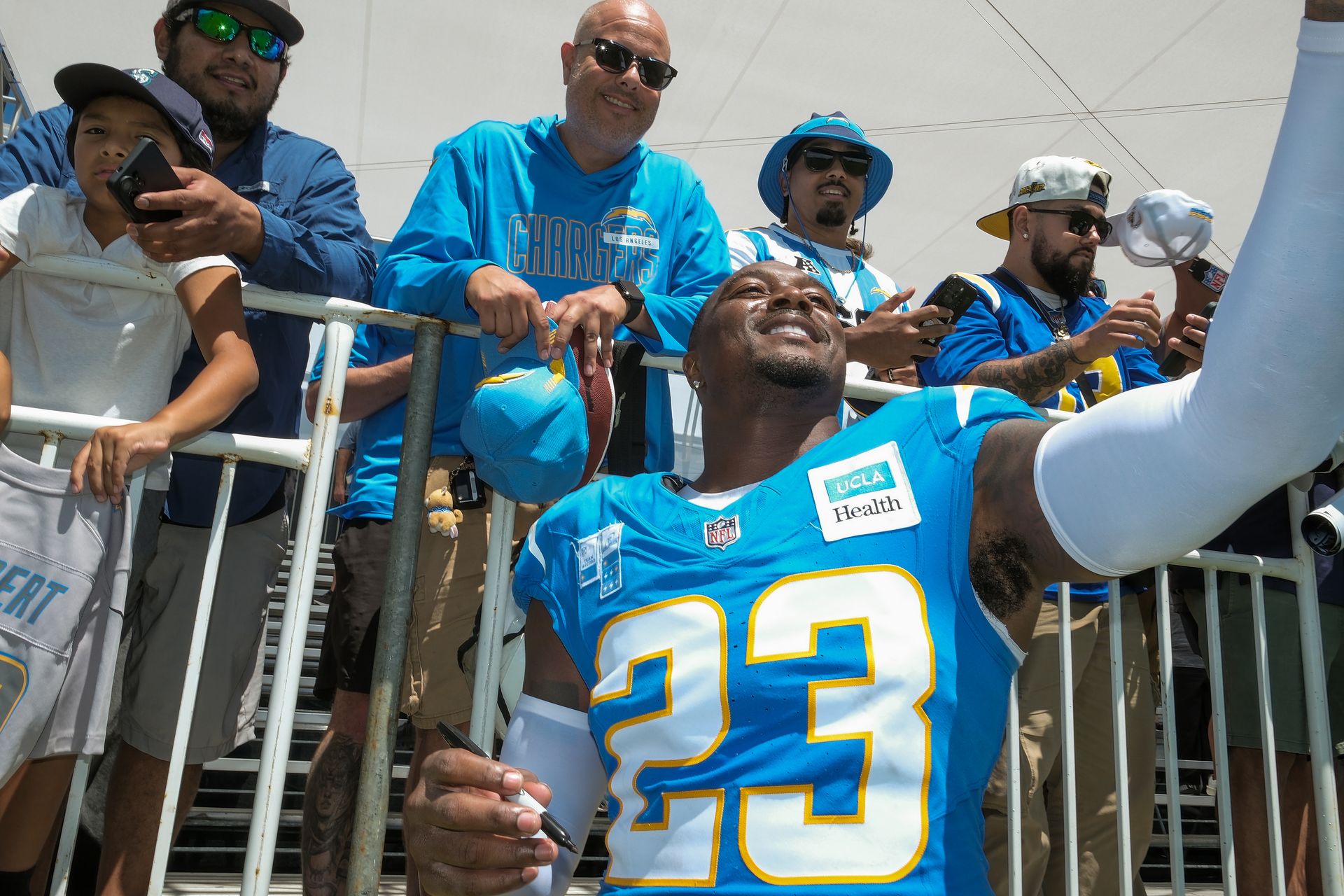 Tony Jefferson takes photos with fans at joint practice