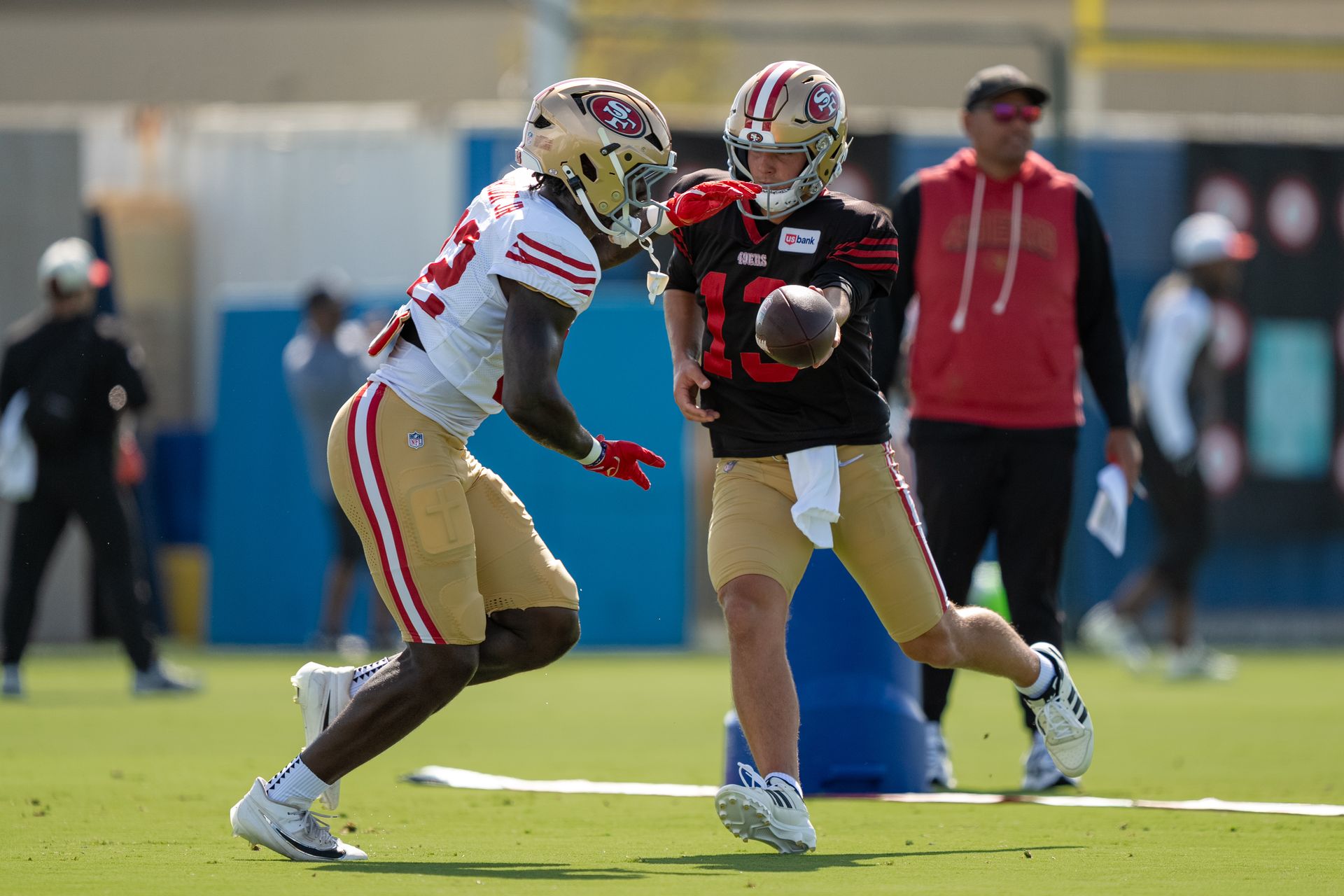 Brock Purdy hands off to Patrick Taylor Jr. in training