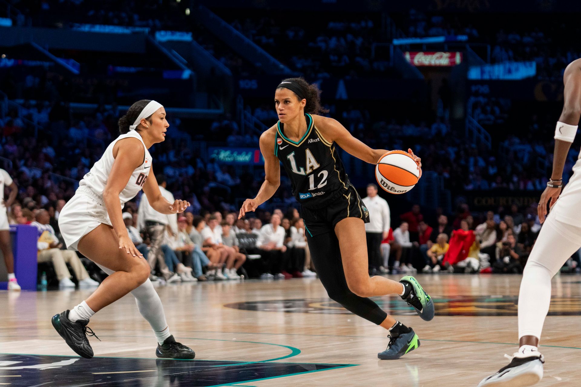 Rae Burrell maneuvers past Dream's defense in a challenging play.