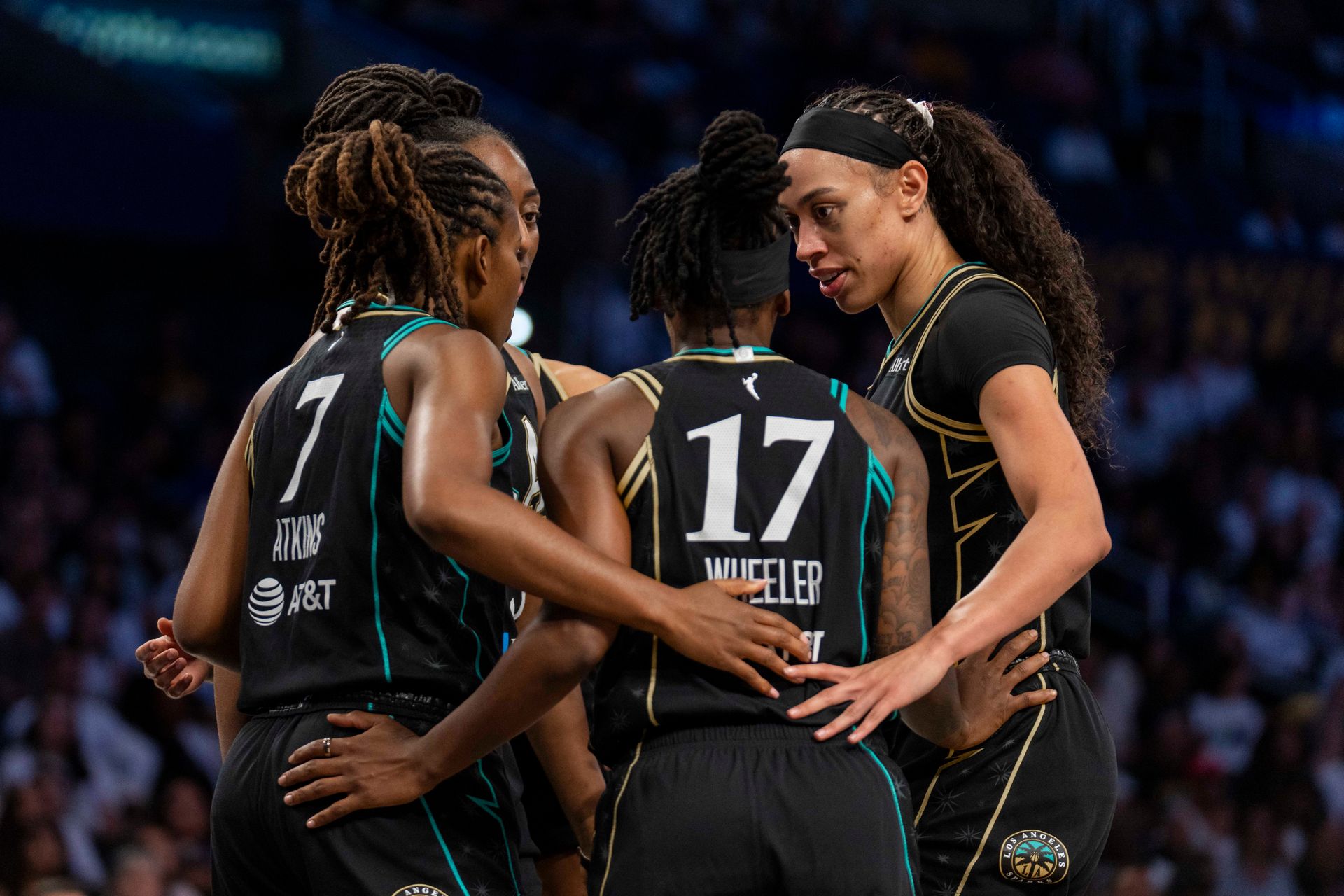 Sparks team huddle after a foul in a tense match.