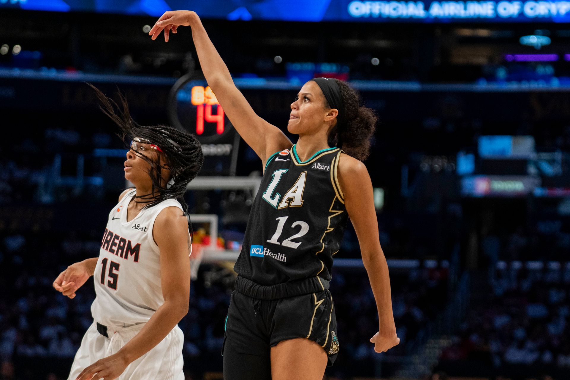 Rae Burrell attempts a three-pointer in a heated moment.