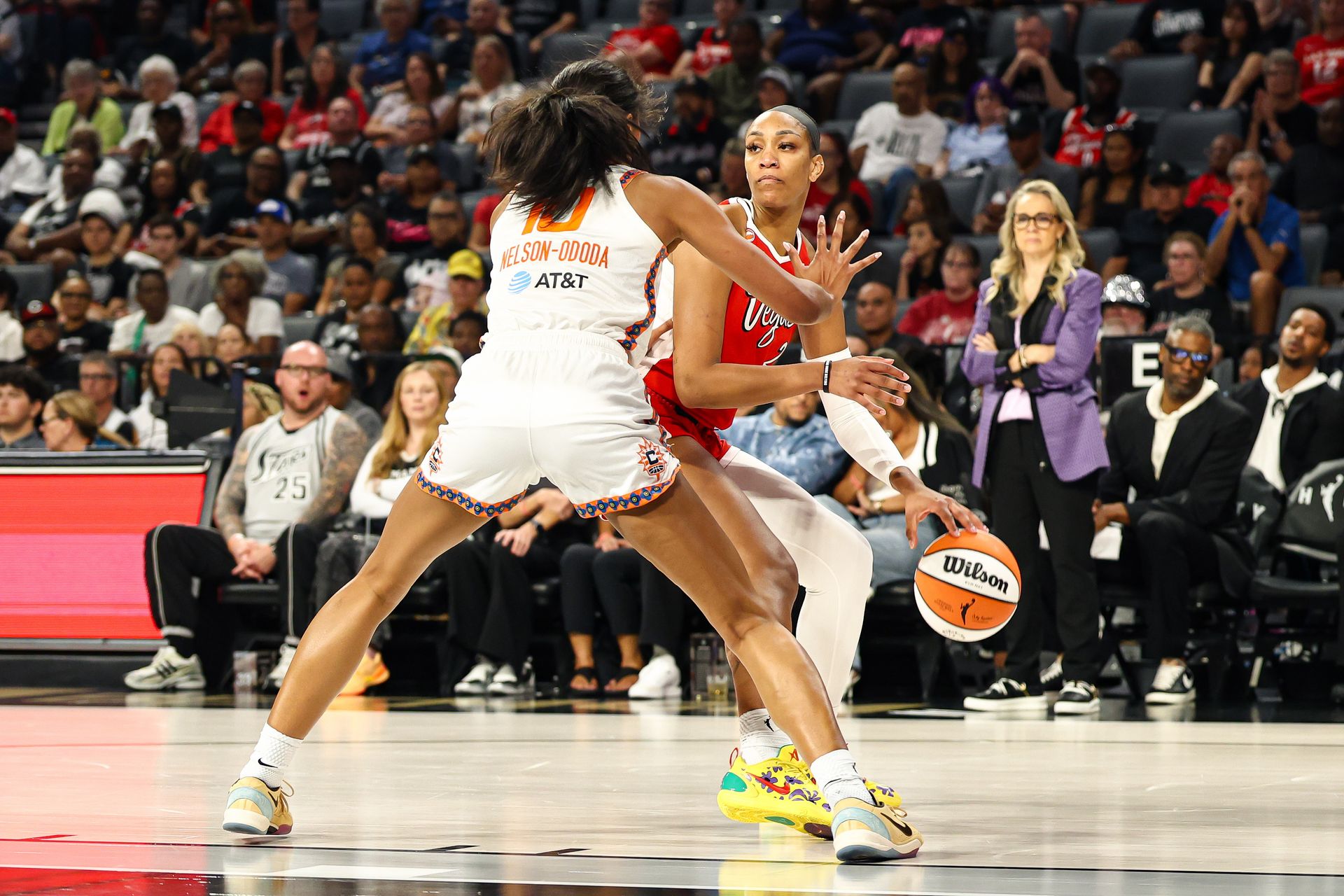A'ja Wilson looks for a pass, guarded by Olivia Nelson-Ododa