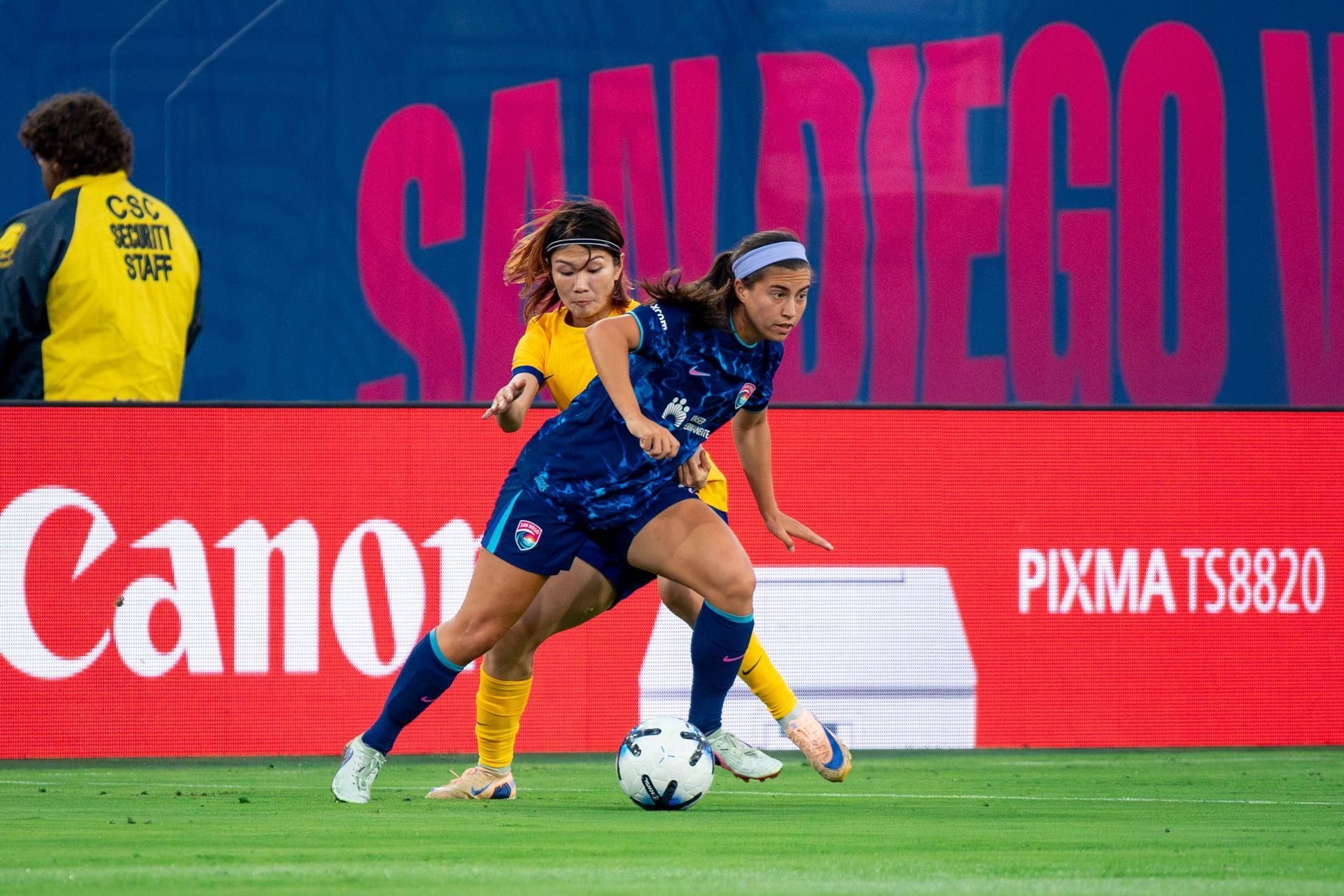 Lia Godfrey maneuvers under pressure in NWSL match against Utah Royals.