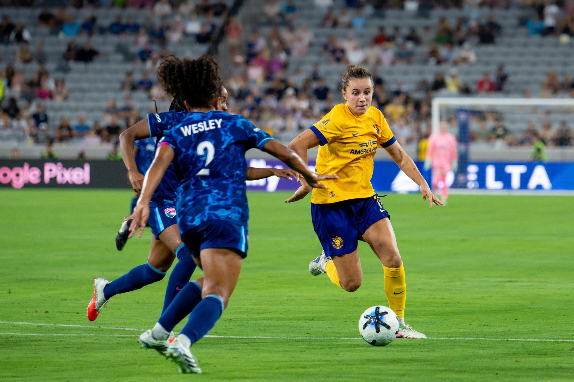 Ana Tejada shows skillful dribbling in NWSL match.
