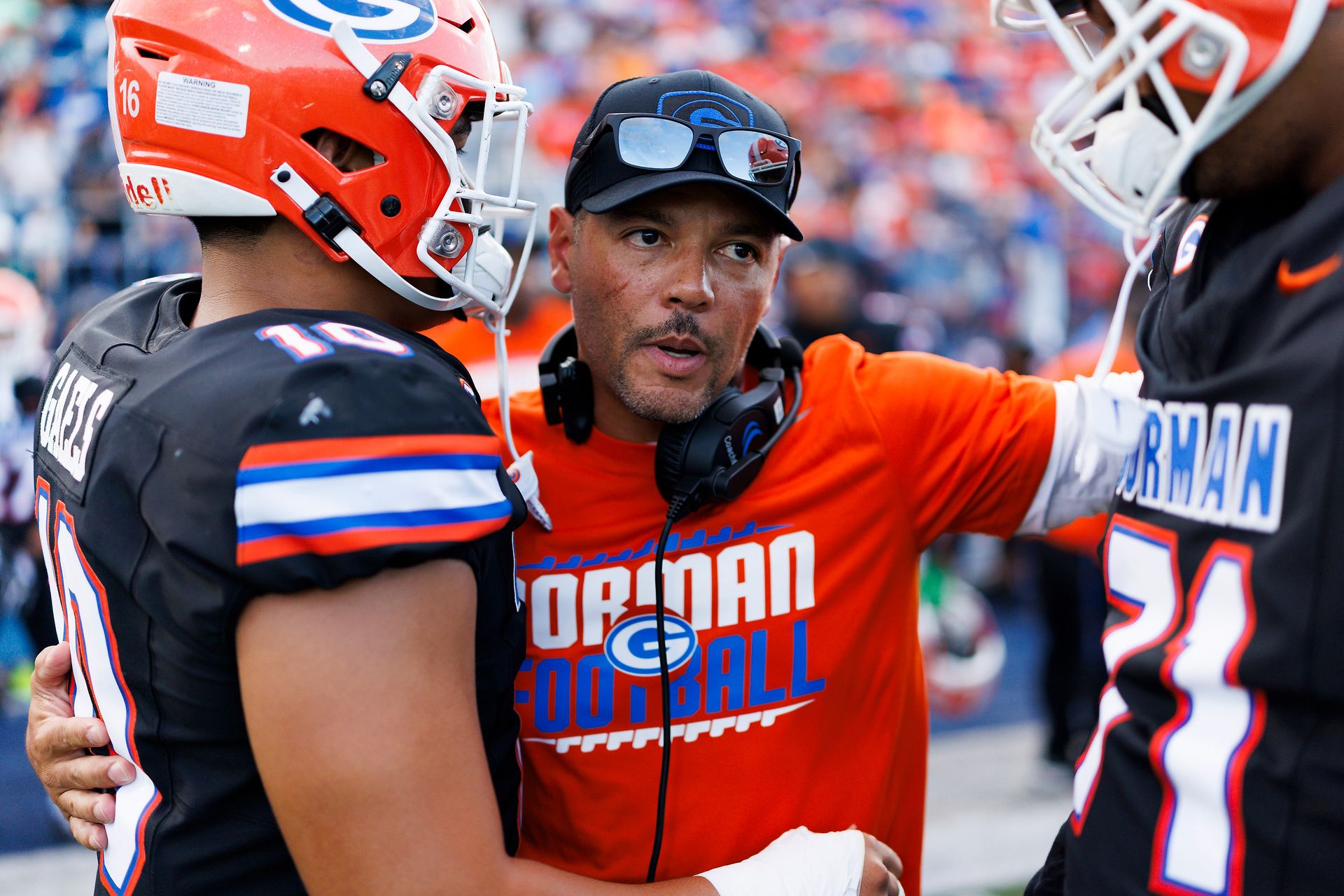 Jason Negro shares a moment with players during the Bishop vs. Bosco game