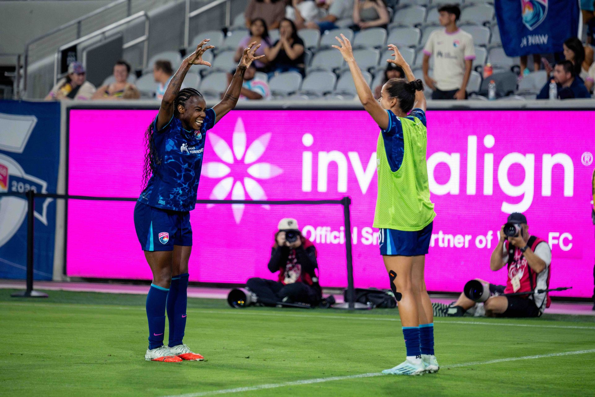 Ludmila celebrates scoring with teammates in NWSL game.