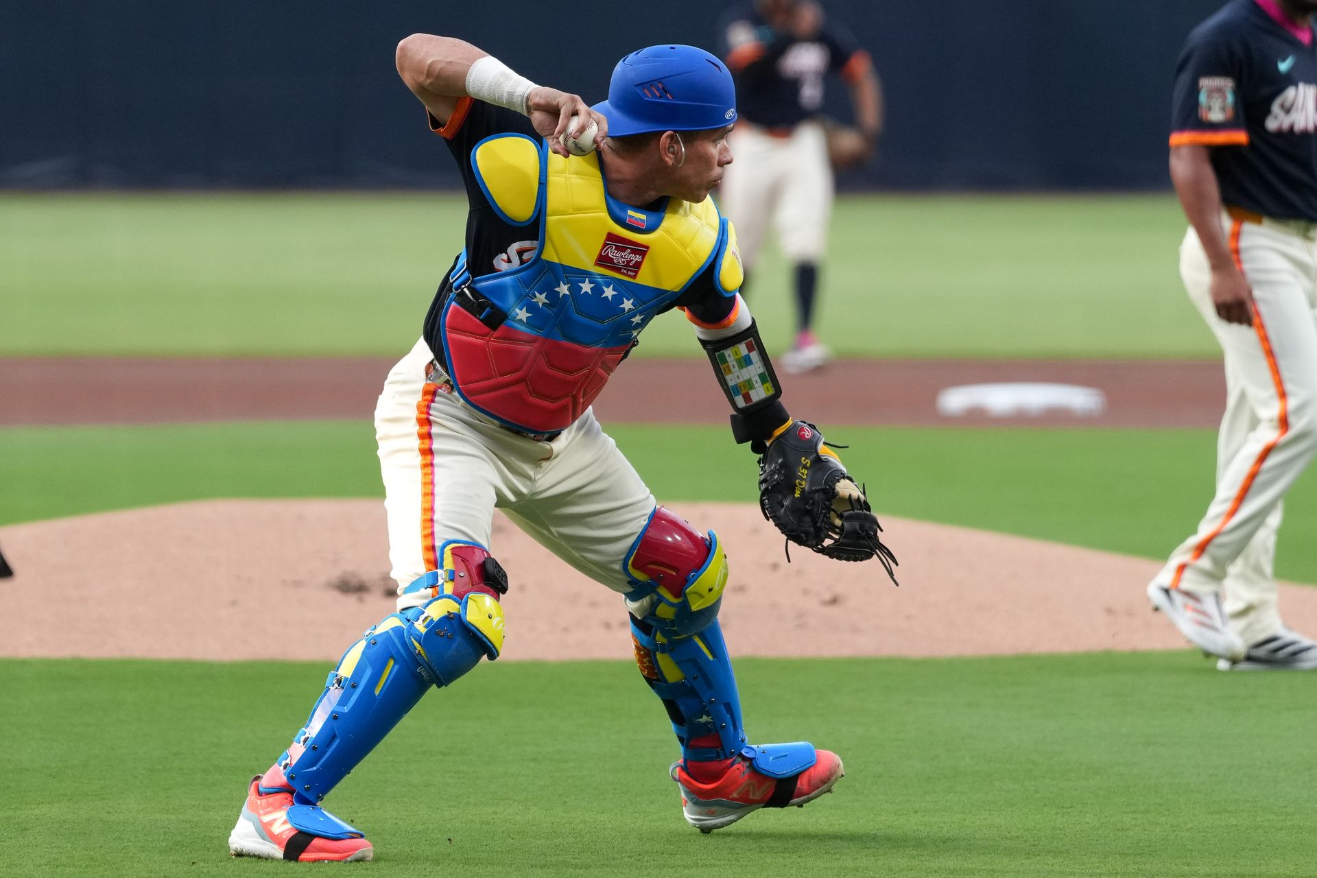 Freddy Fermin throws to first base in game against Twins