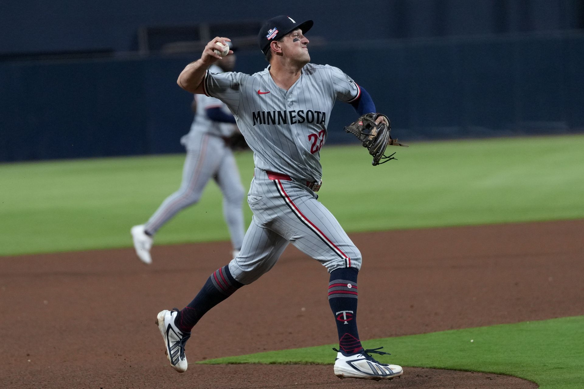 Brooks Lee makes a throw to first base against the Padres