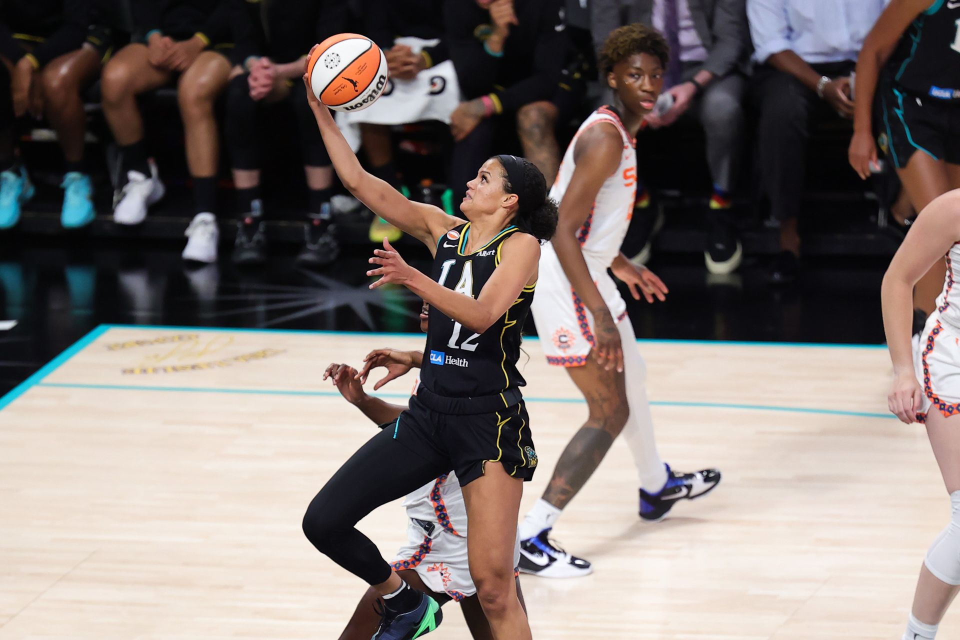 Rae Burrell attempts a layup in a competitive match
